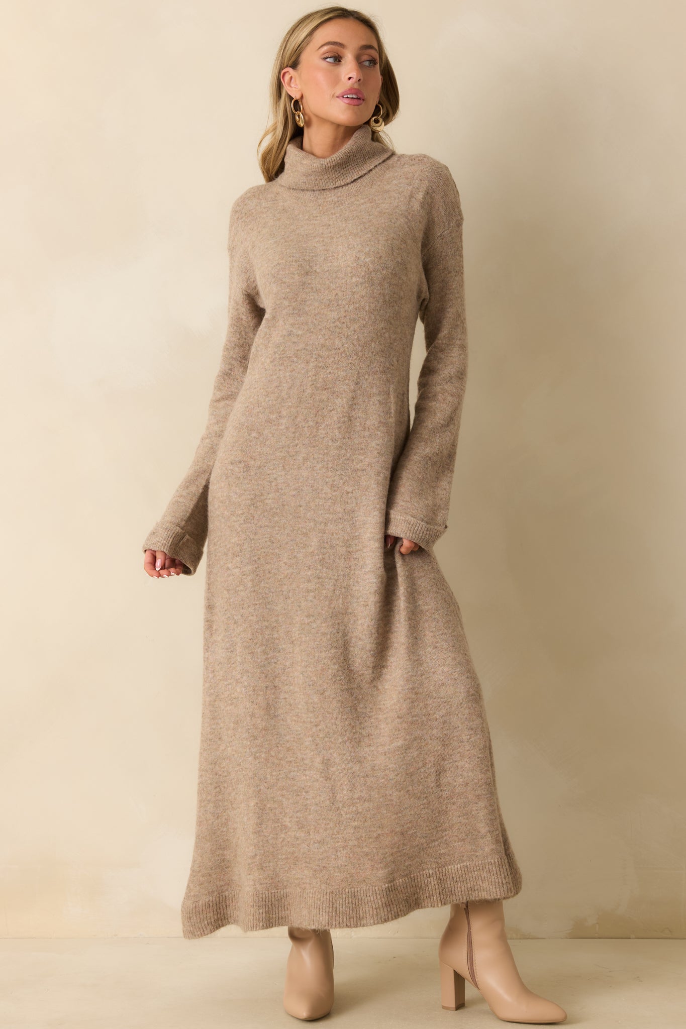 Front angle of the beige knit maxi dress emphasizing the turtleneck neckline and smooth knit construction.