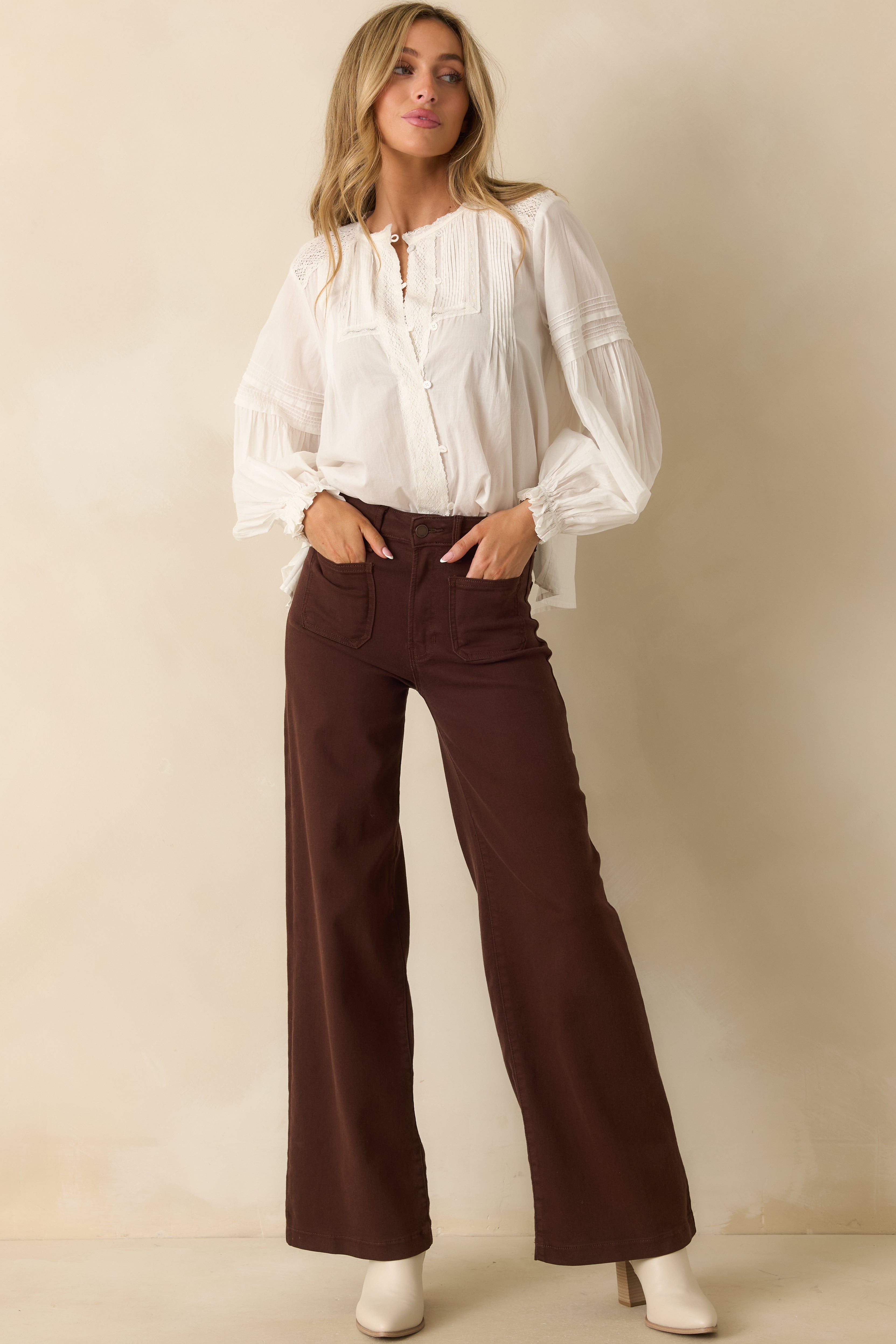 Front view of white blouse with lace accents, flowing peasant sleeves, and airy silhouette.