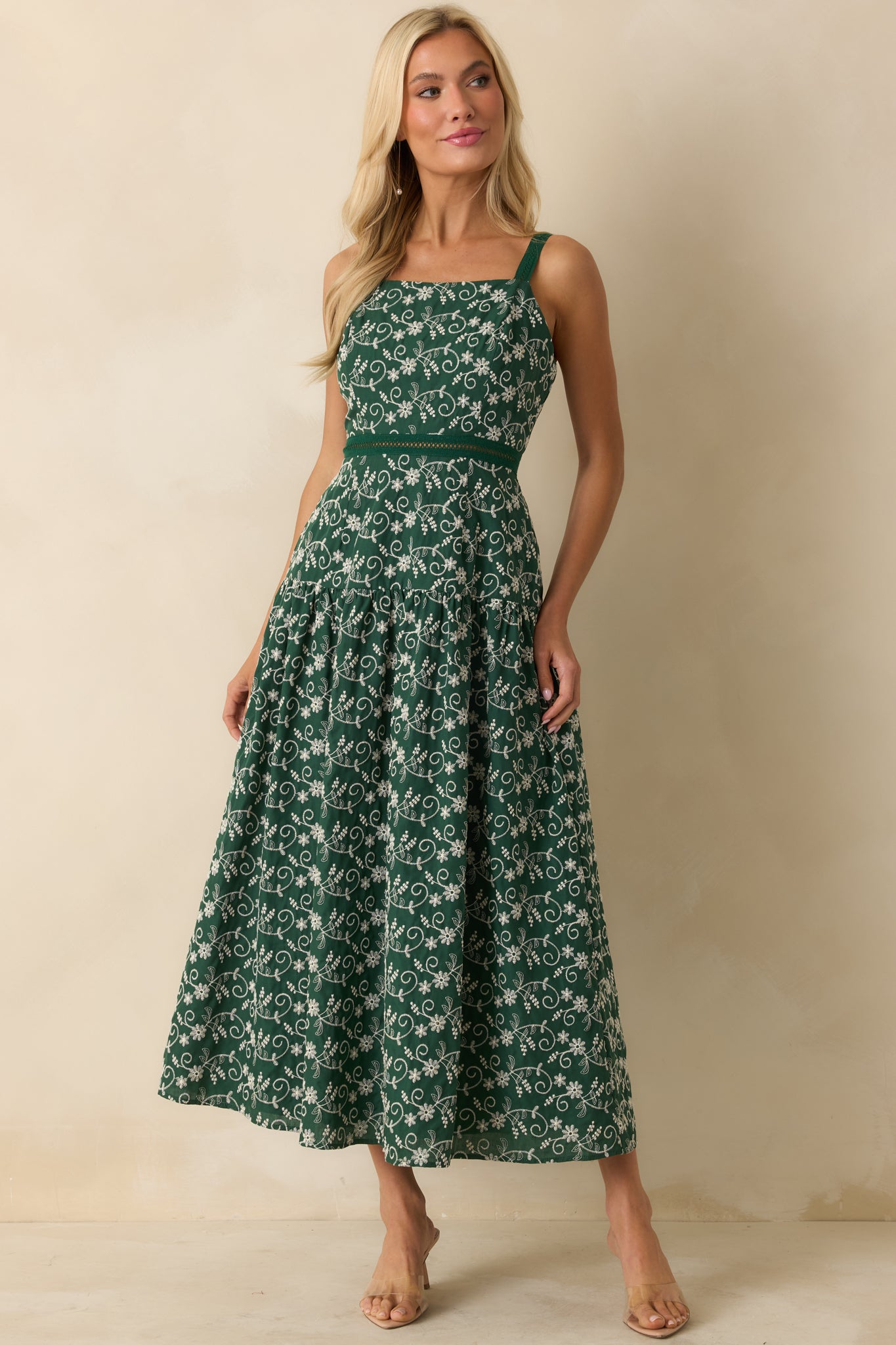 Full-length hunter green dress showcasing open ladder-lace waist, functional pockets, and fitted upper bodice.