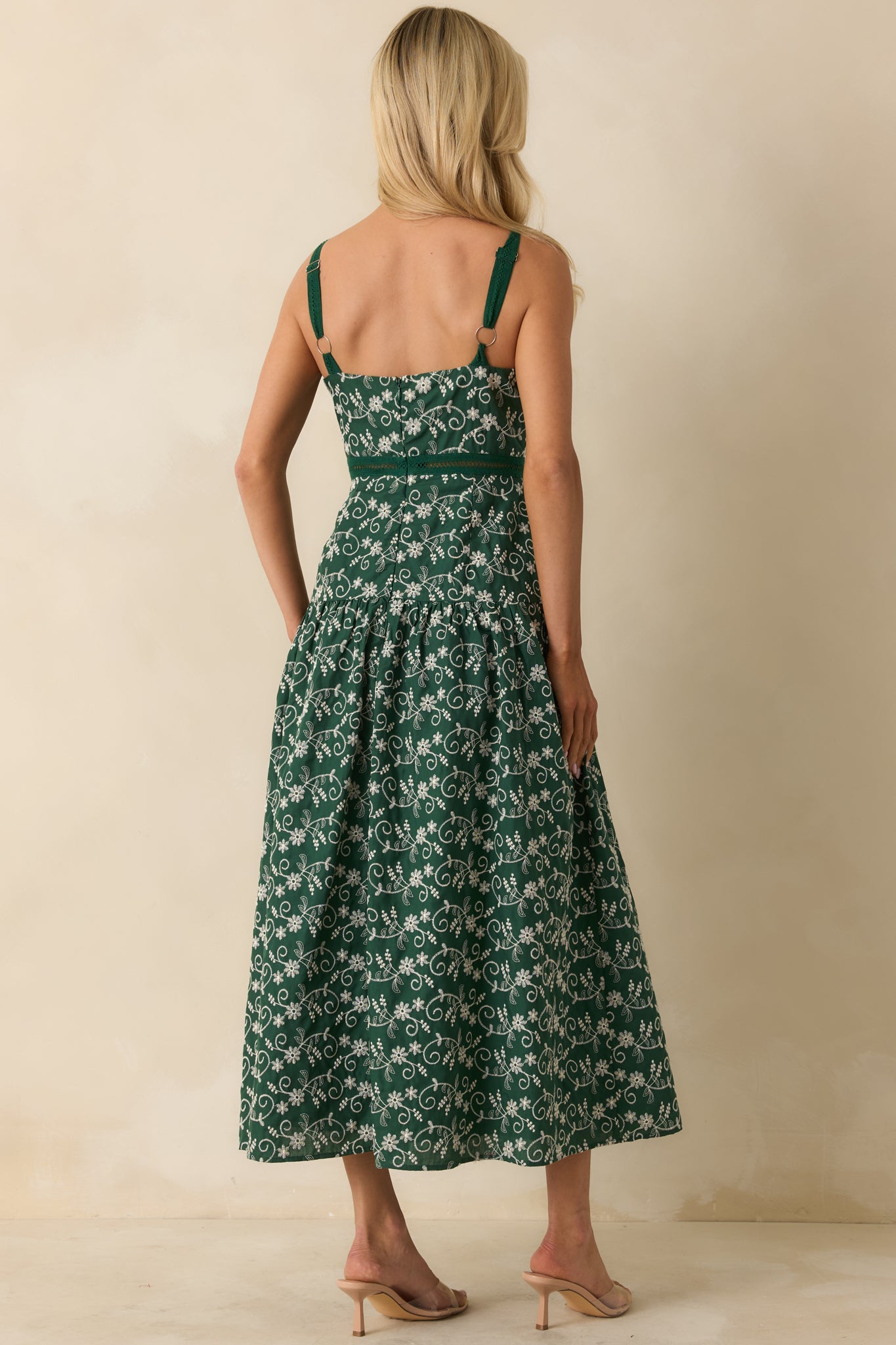 Rear view of hunter green maxi dress showing hidden zipper closure, adjustable straps, and drop waist silhouette.