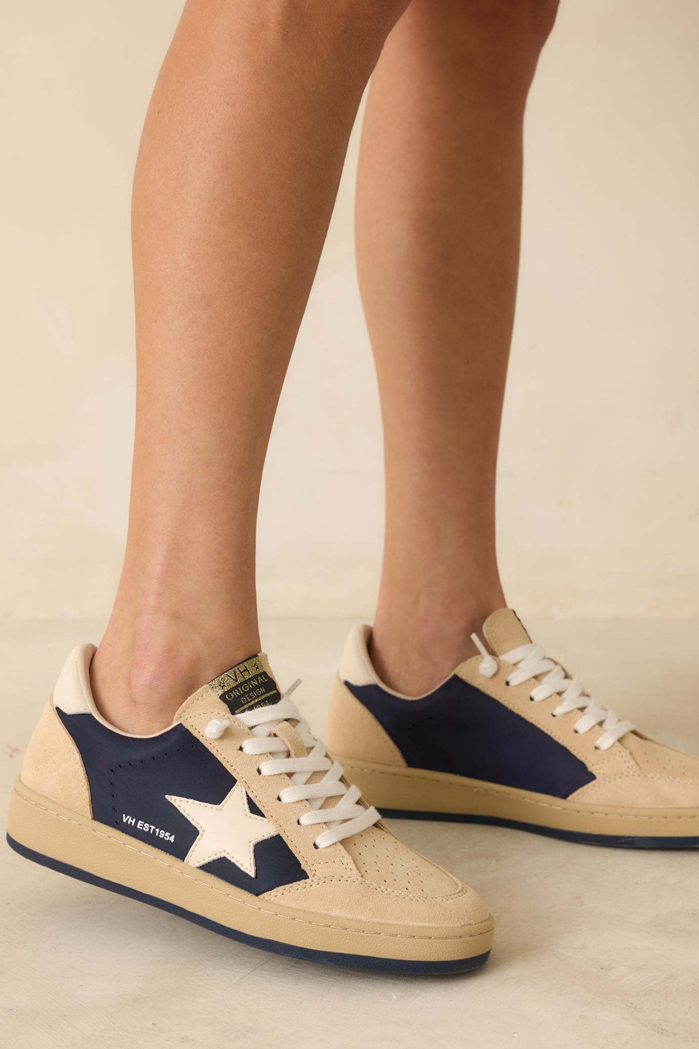 Cropped view focusing on the suede side panels and contrasting navy star logo patch.