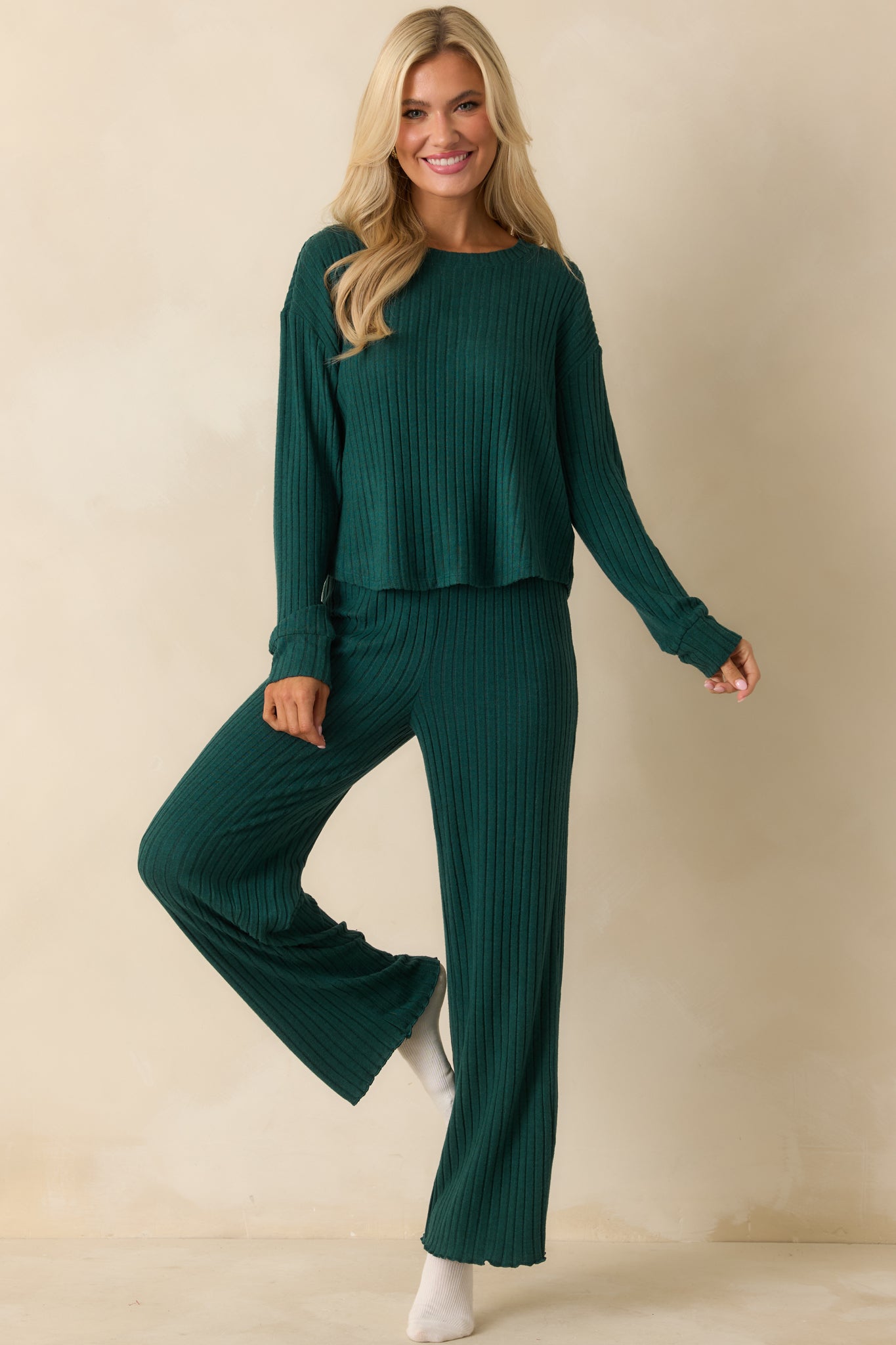 Silky green crew-neck top with long sleeves, relaxed fit, and smooth rib-knit texture.