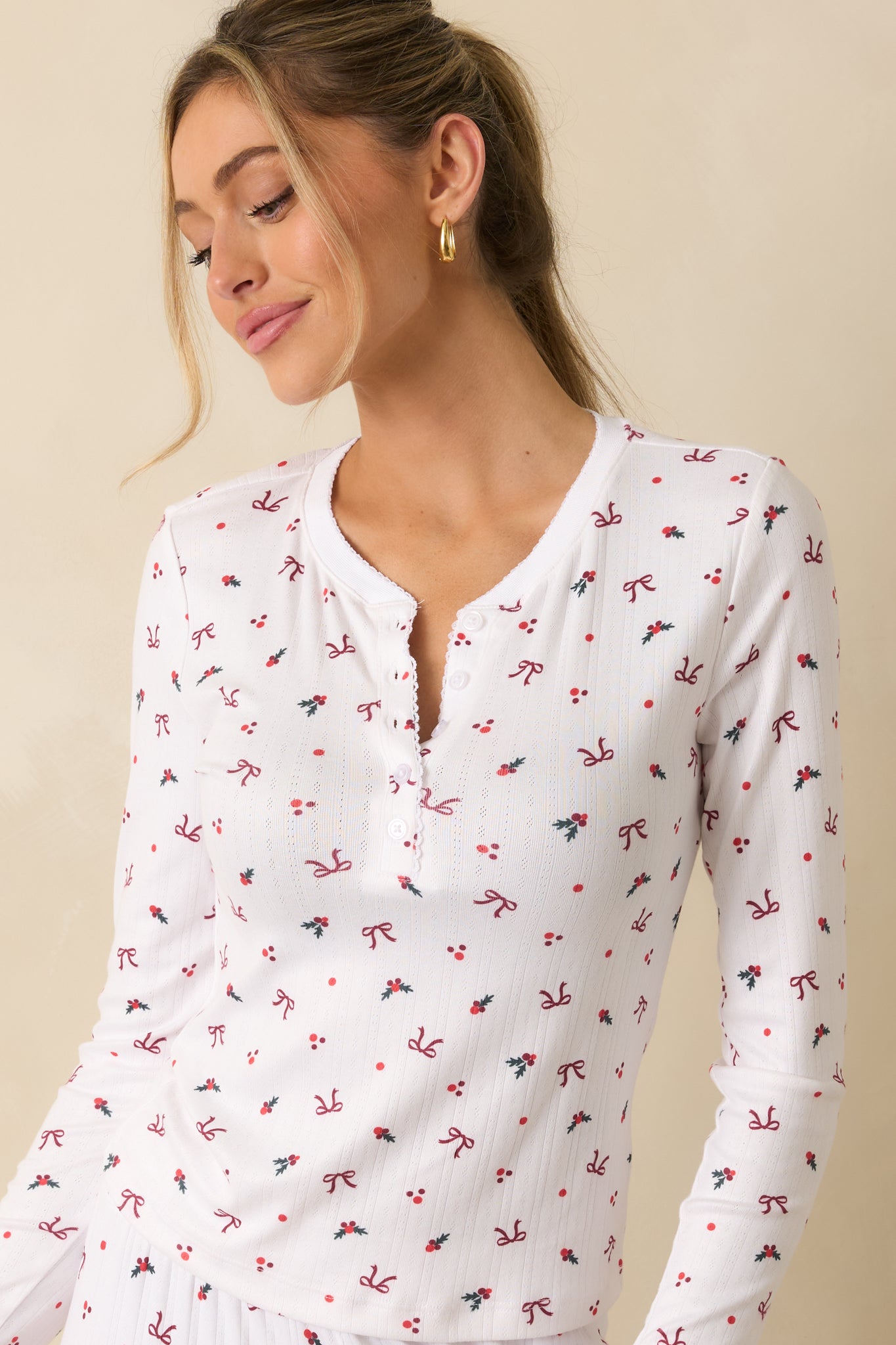 Front detail of white long-sleeve henley, emphasizing the button placket and soft-wash Pointelle fabric.