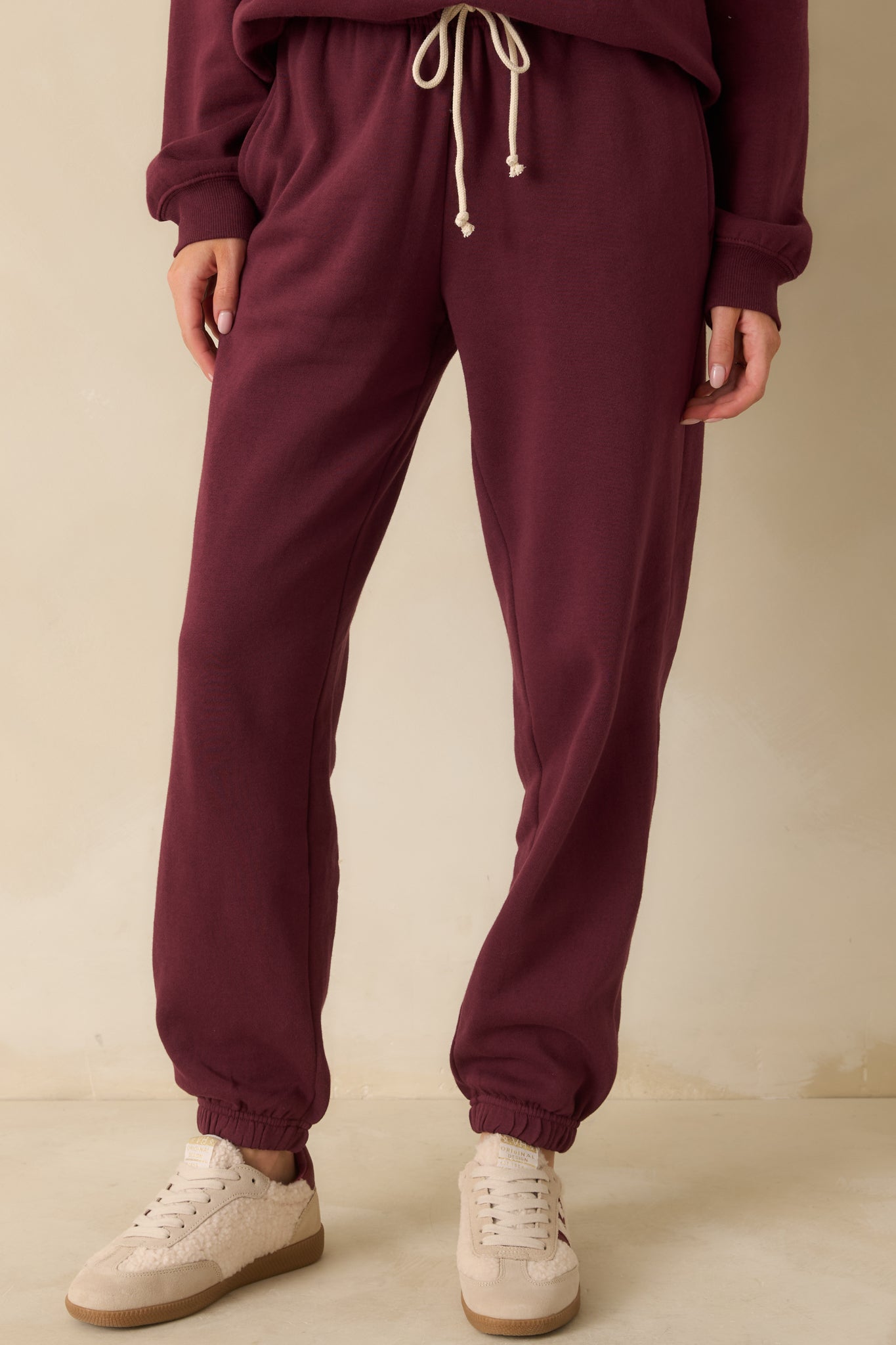 Close view of the fleece texture and roomy pocket design on the front of the joggers.