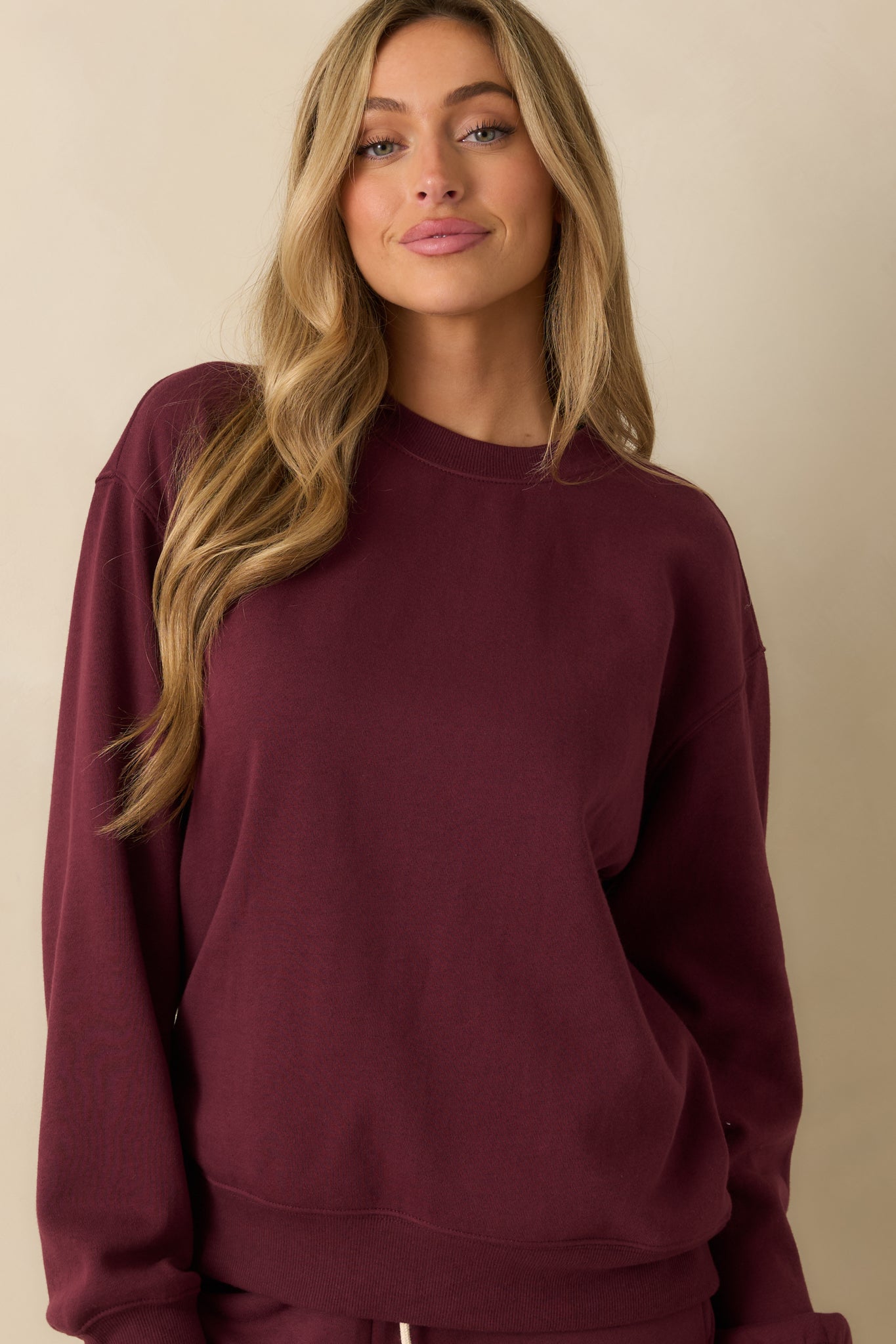 Focus on the fleece texture and stitching, emphasizing the sweatshirt’s cozy feel.