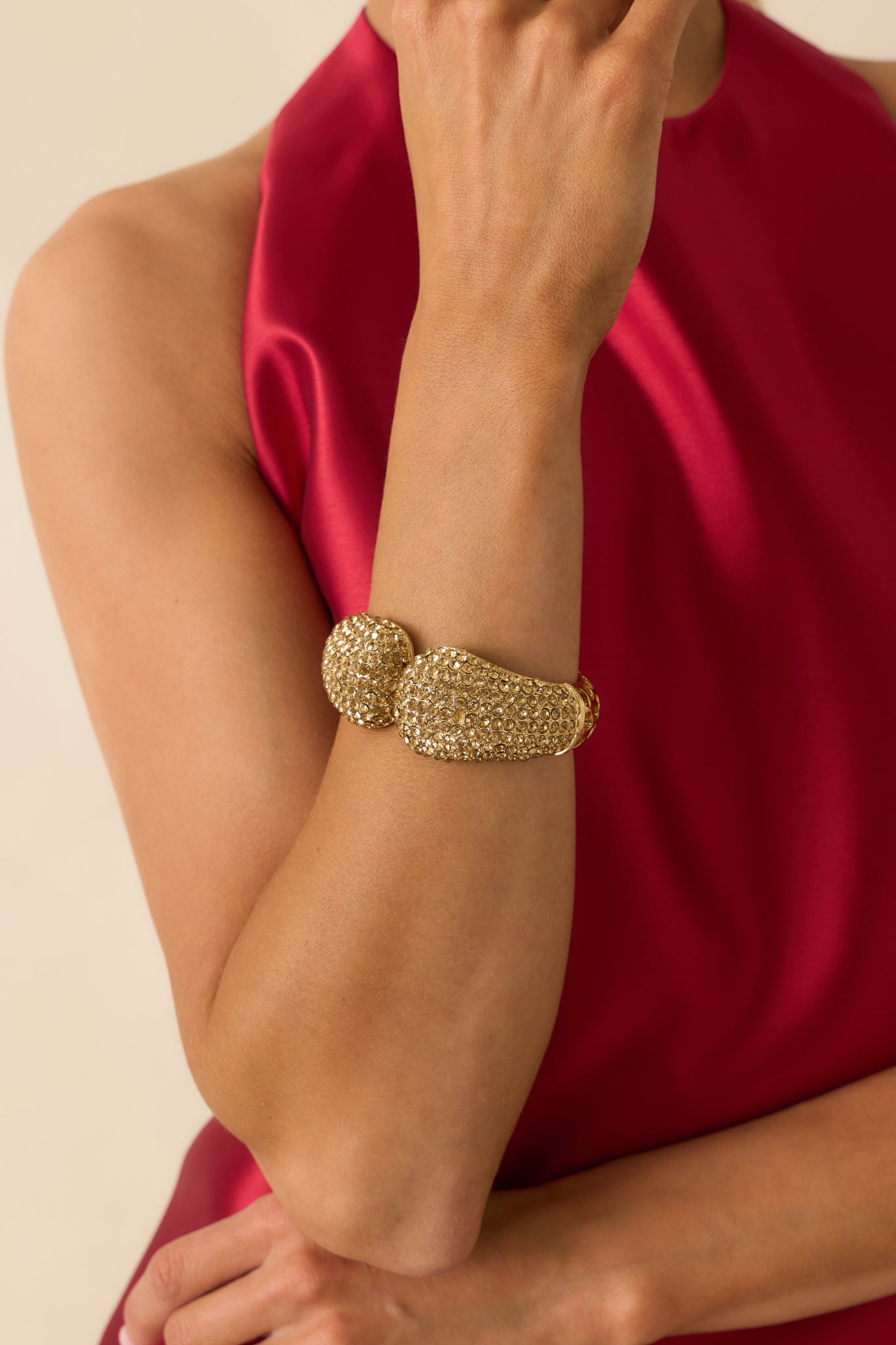 Close-up of the gold bracelet’s rhinestone embellishments and precise vent openings, emphasizing craftsmanship and shine.
