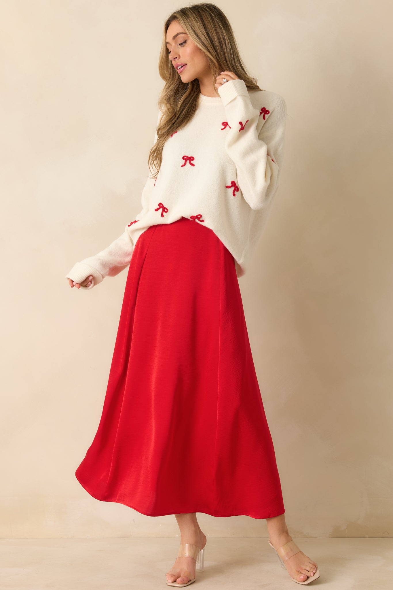 High-rise red midi skirt in woven satin, showcasing A-line shape and soft, flowing fabric.