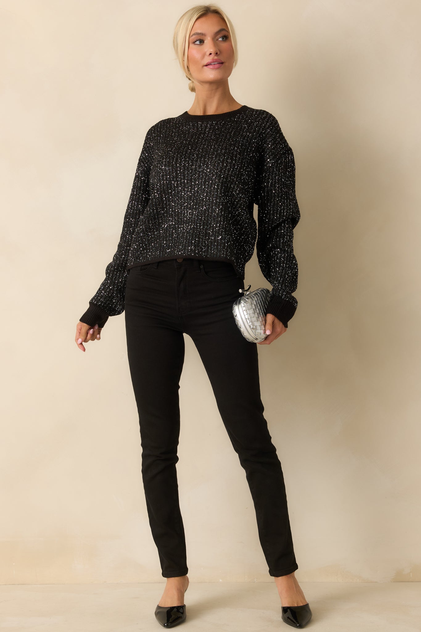 Front view of the black ribbed knit sweater with tonal sequins, crew neckline, and long sleeves.