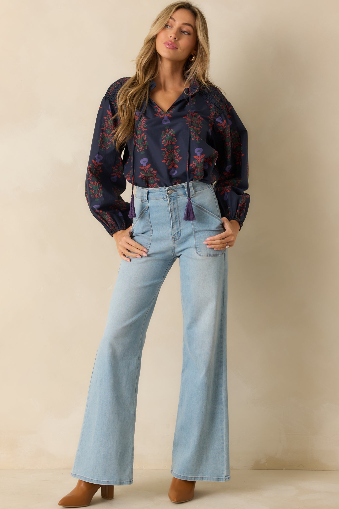 Navy cotton peasant top with a flowing silhouette, decorative tie closures, and lightweight fabric.