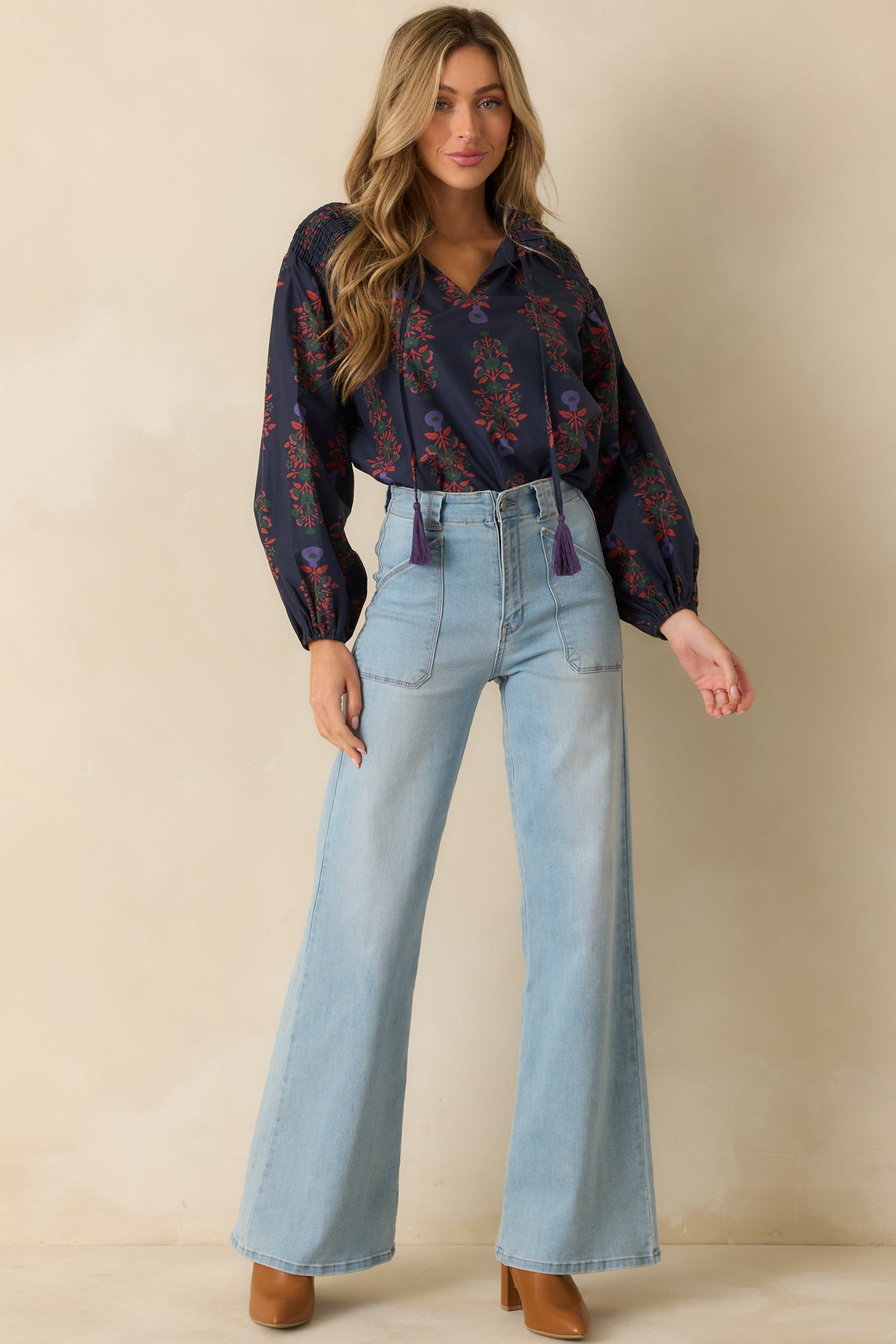 Minimal navy floral top featuring a relaxed shape, long puff sleeves, and elasticized cuff finish.