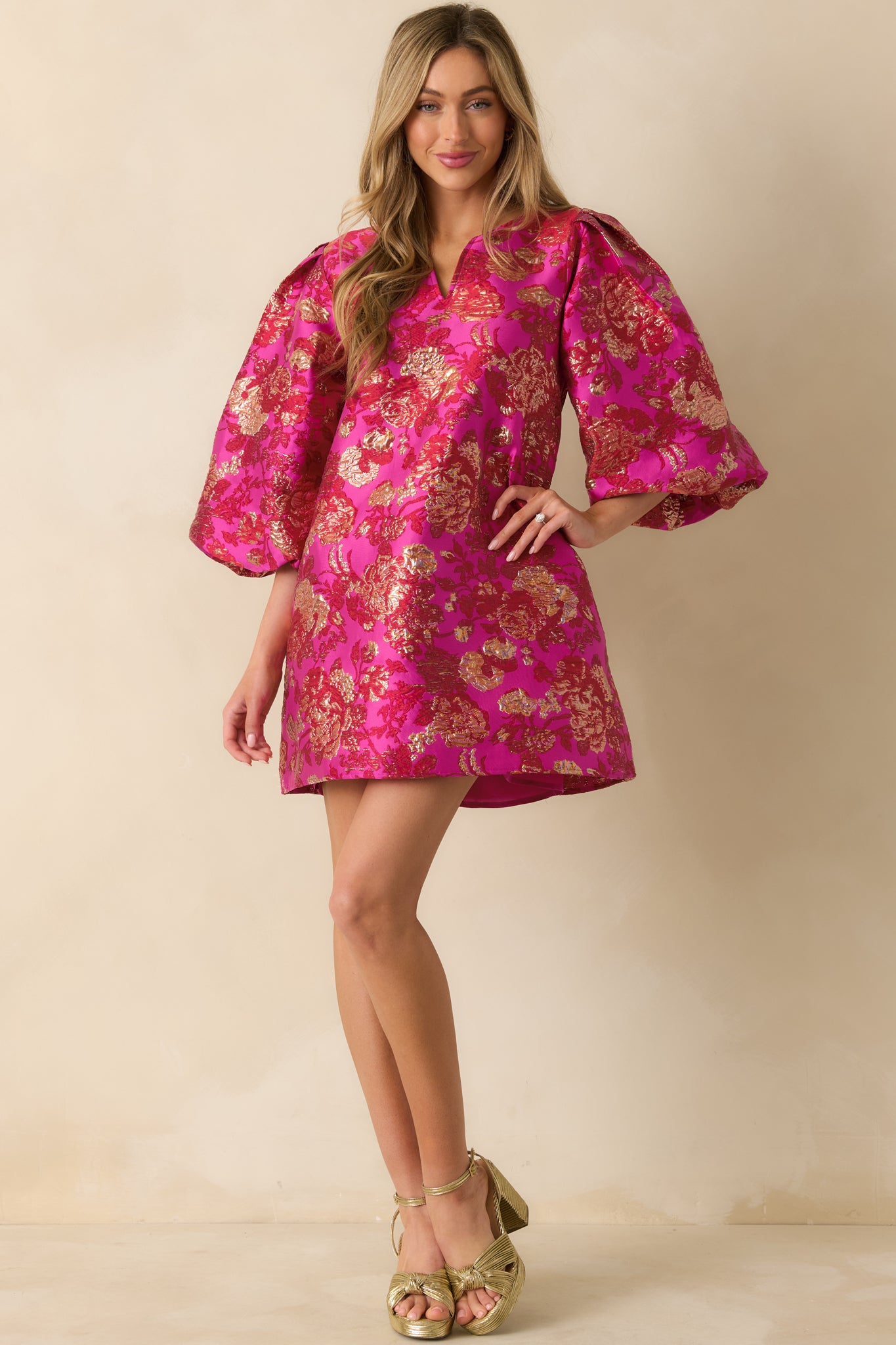 Hot pink floral jacquard mini dress with a V-neckline and statement puff sleeves.