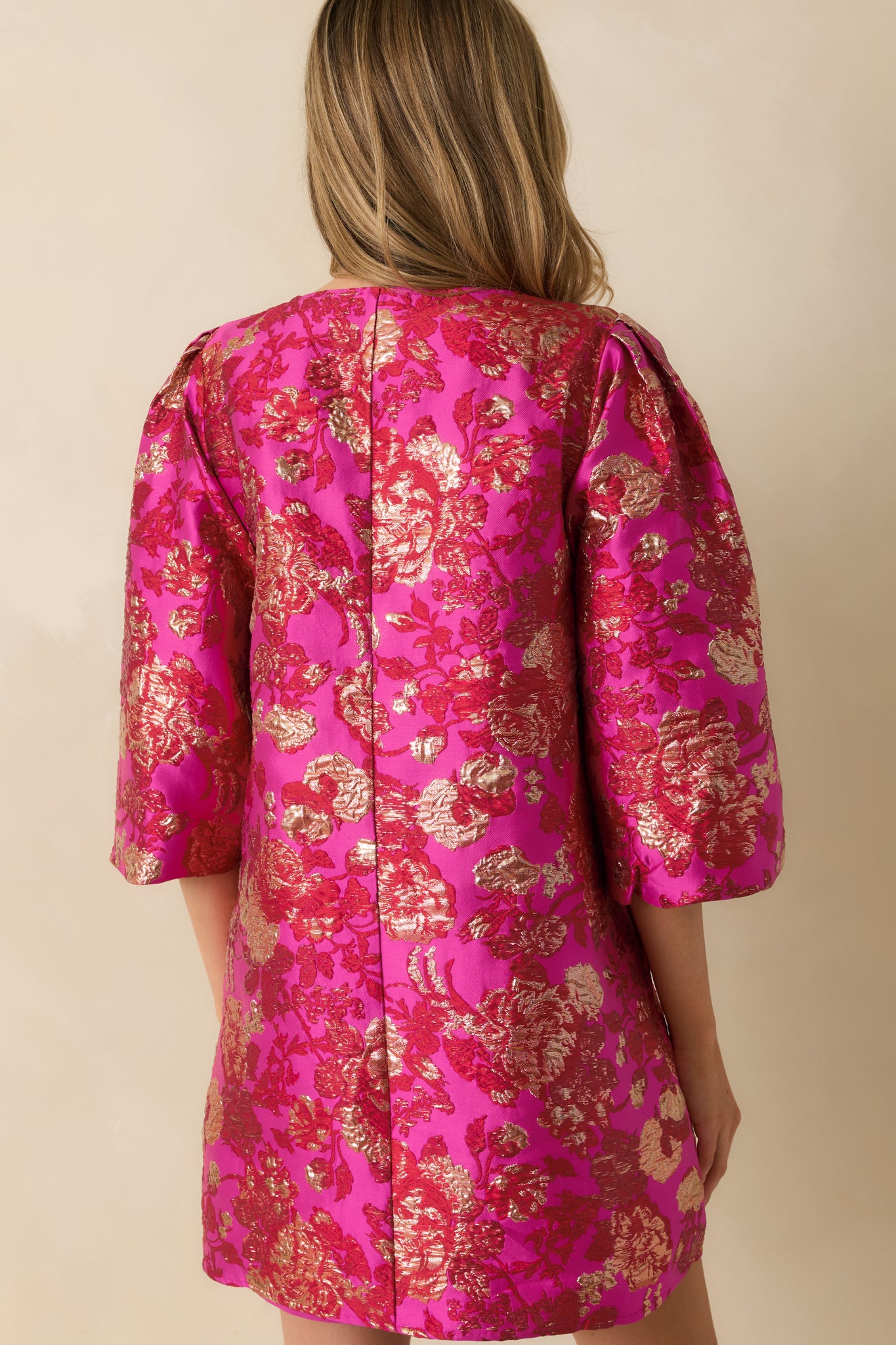 Rear view of the hot pink jacquard mini dress showing the relaxed fit and subtle sheen.