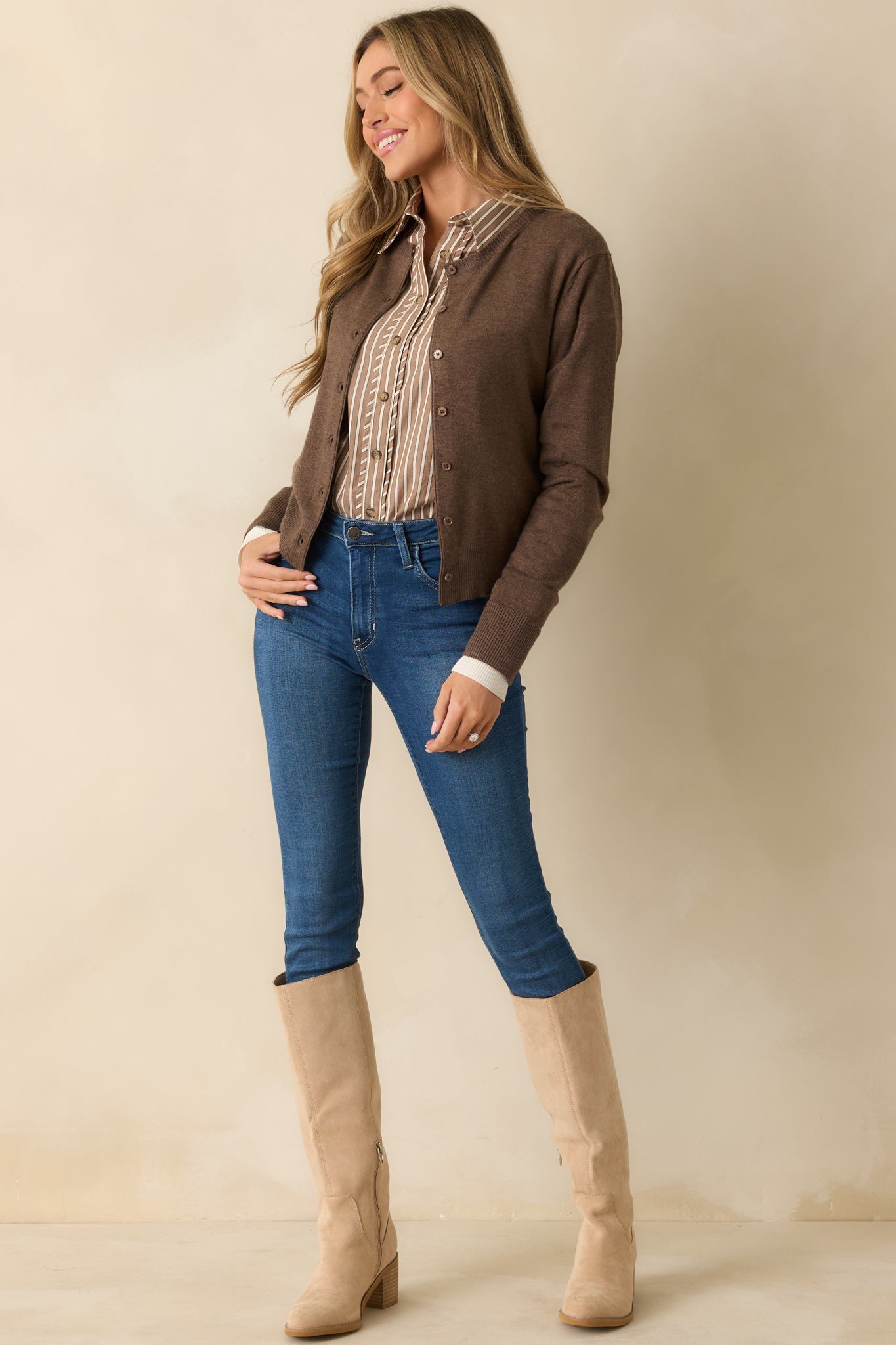 Lightweight brown cardigan featuring ribbed hems and faux white layered cuffs for added detail.