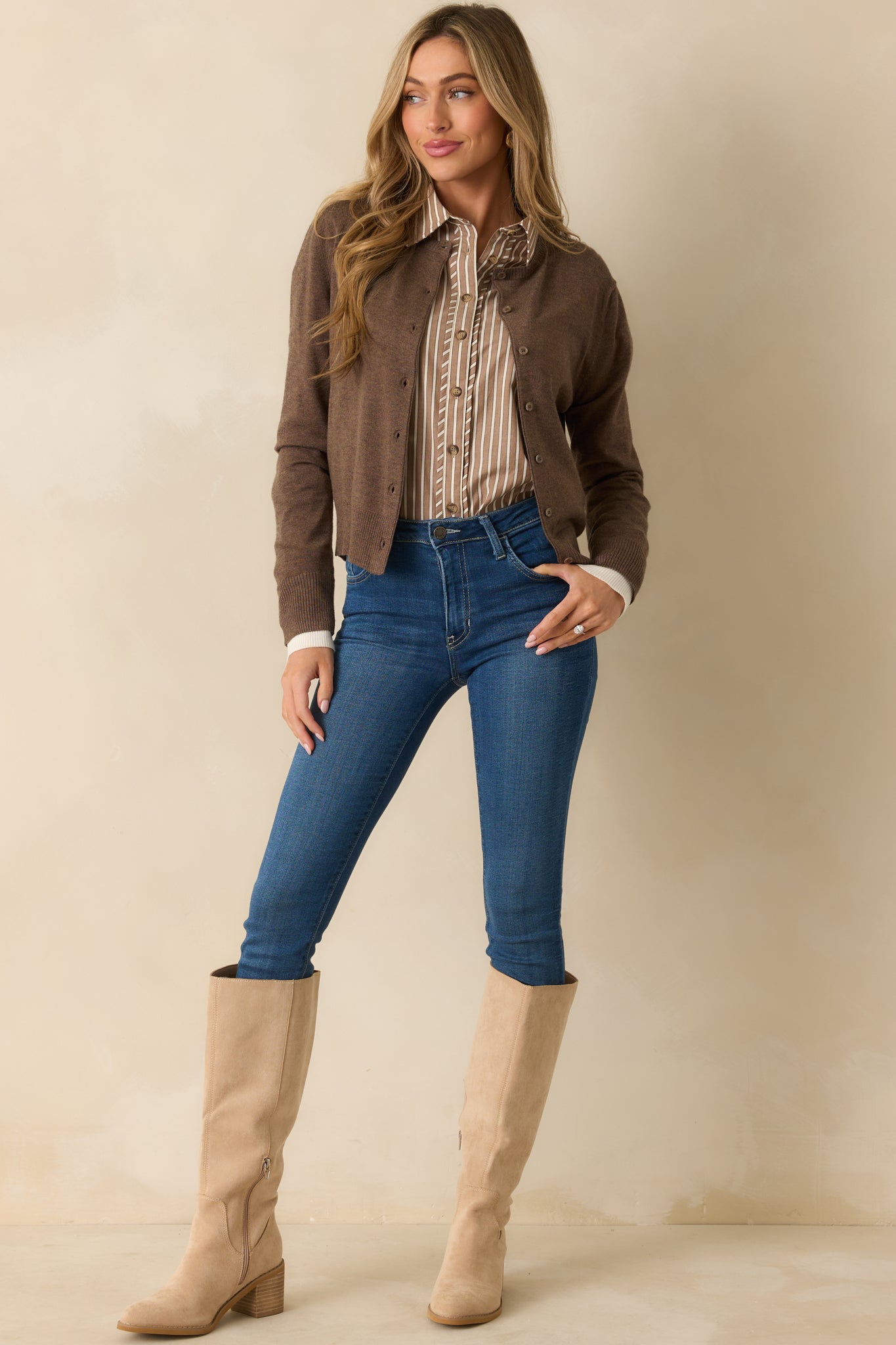 Relaxed-fit brown cardigan with functional buttons and a classic crew neckline.