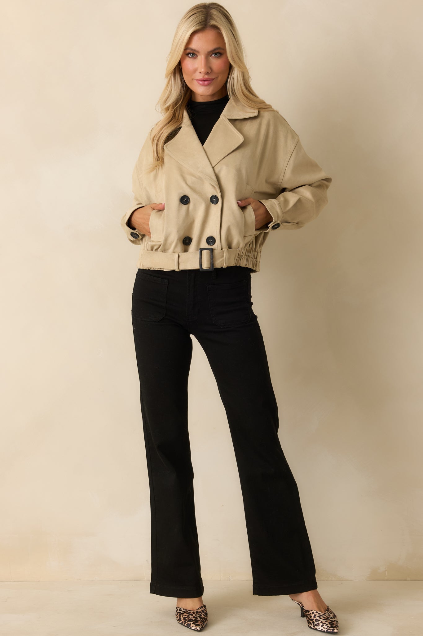 Tan cotton double-breasted jacket showing notched lapels and long sleeves.