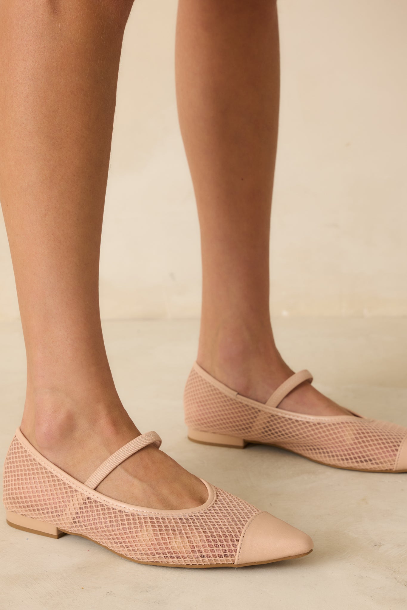 Side view of beige mesh flats highlighting pointed toe, cushioned sole, and beige trim.
