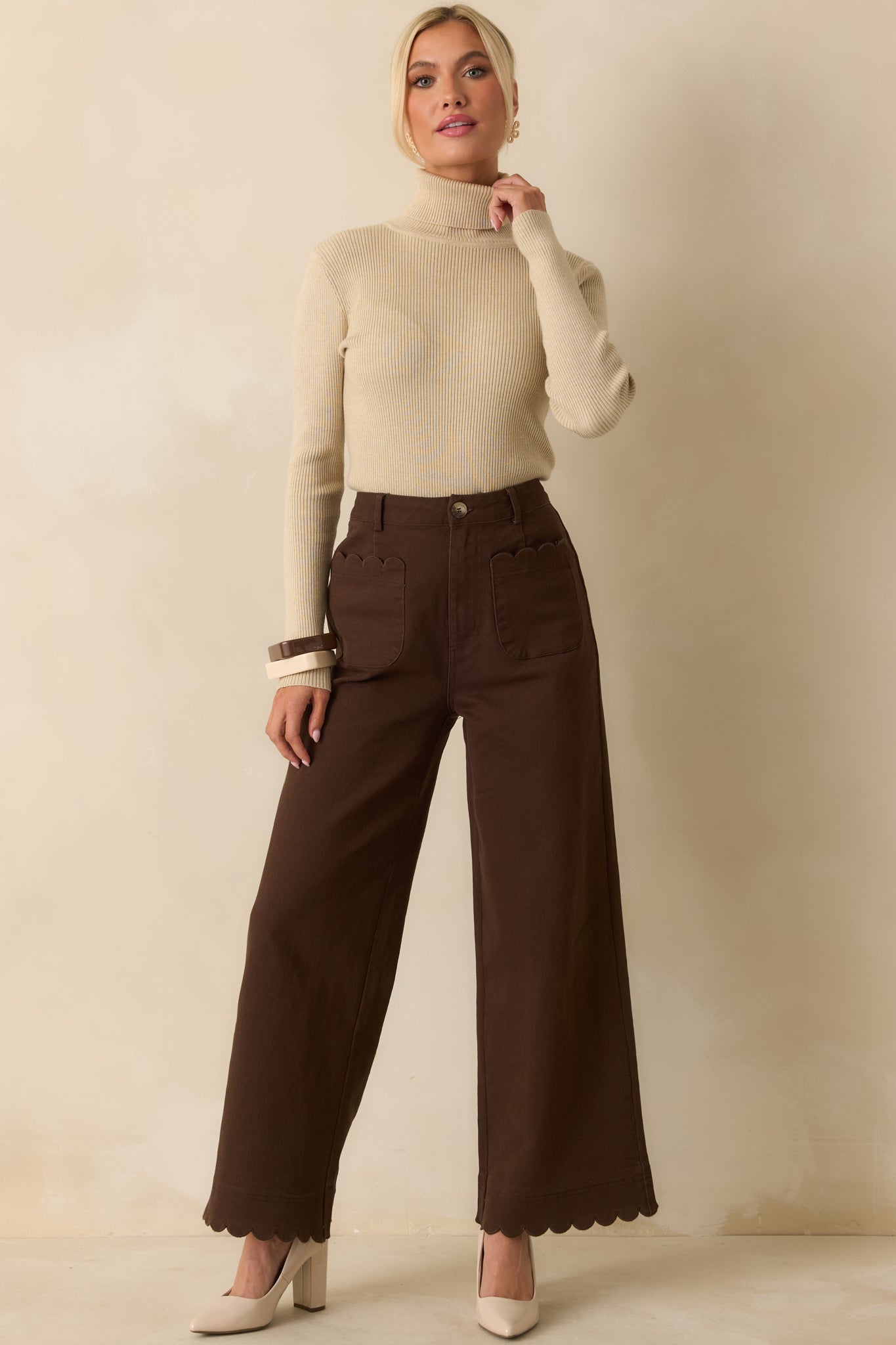 Full body photo of sweater highlighting long sleeves and subtle ribbed detailing along the body.