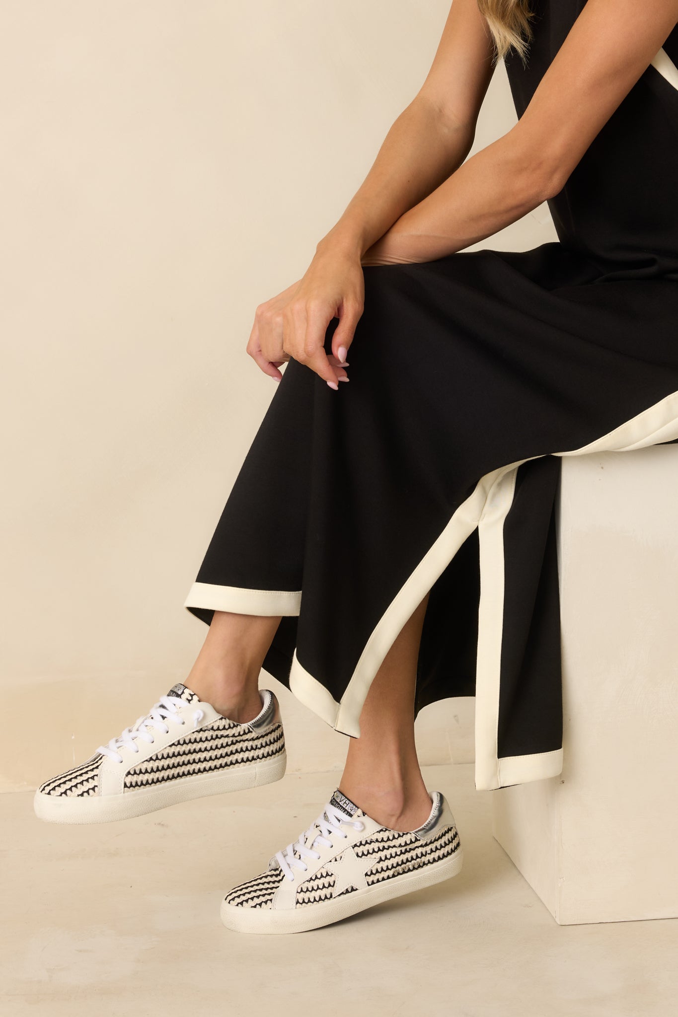 Close-up of the jersey knit fabric showing soft texture and contrasting ivory trim details.