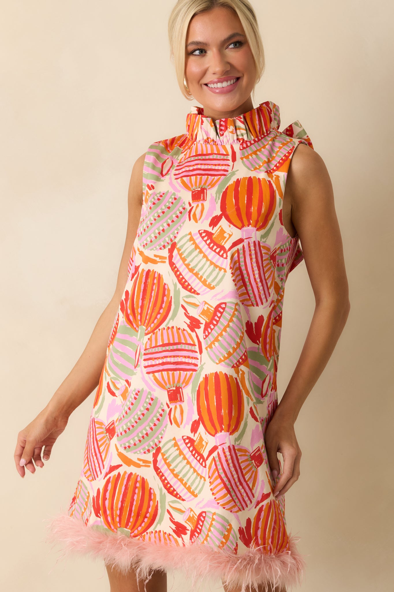 The dress’s patterned woven cotton shines with its mix of ornamental colors and ruffled neckline charm.