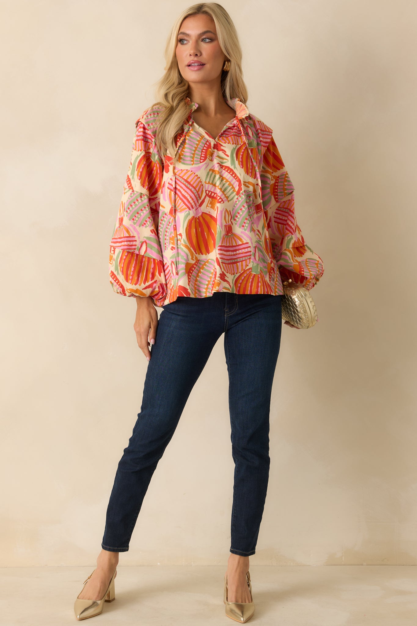 The peasant-style top highlights its lightweight woven fabric, flowing shape, and detailed ornament pattern.