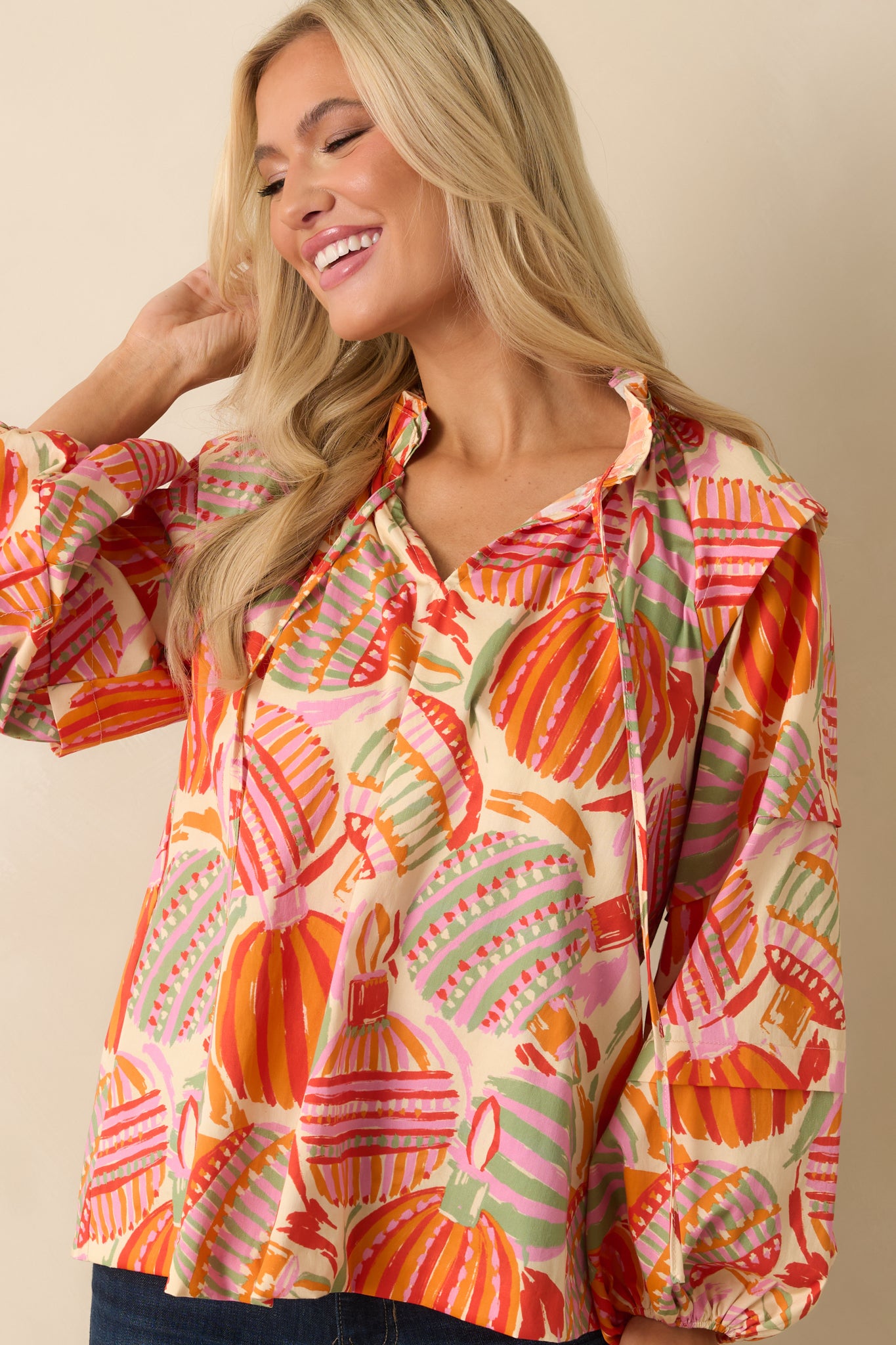 The neckline ties and multicolor motifs combine for a textured, ornamental look true to the peasant style.