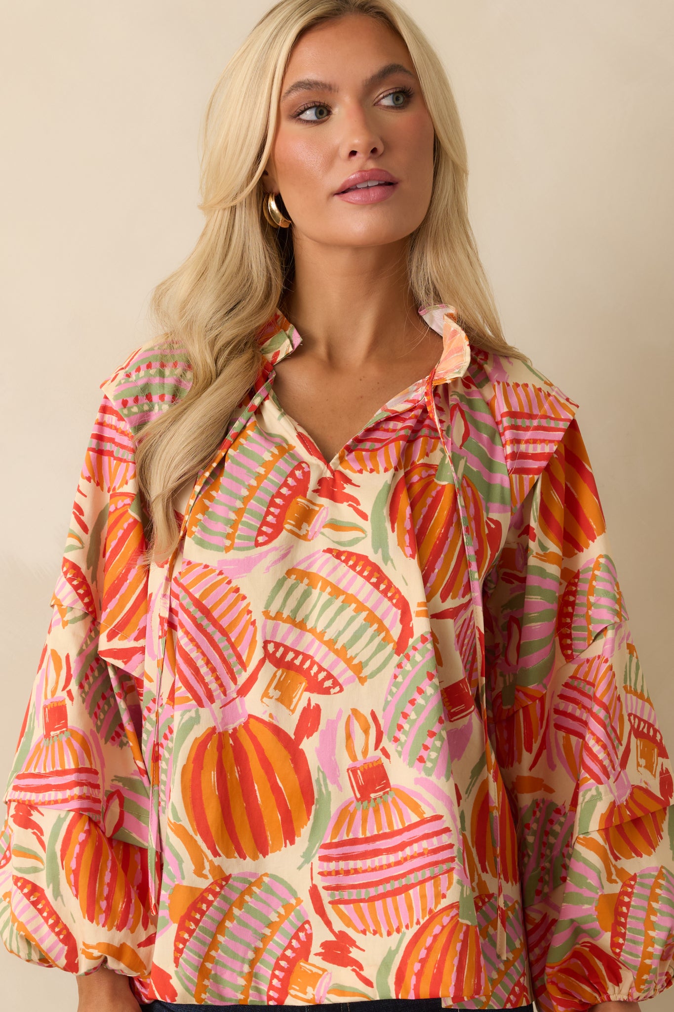 The top displays its multicolor ornament print with a relaxed silhouette and a tied split neckline.