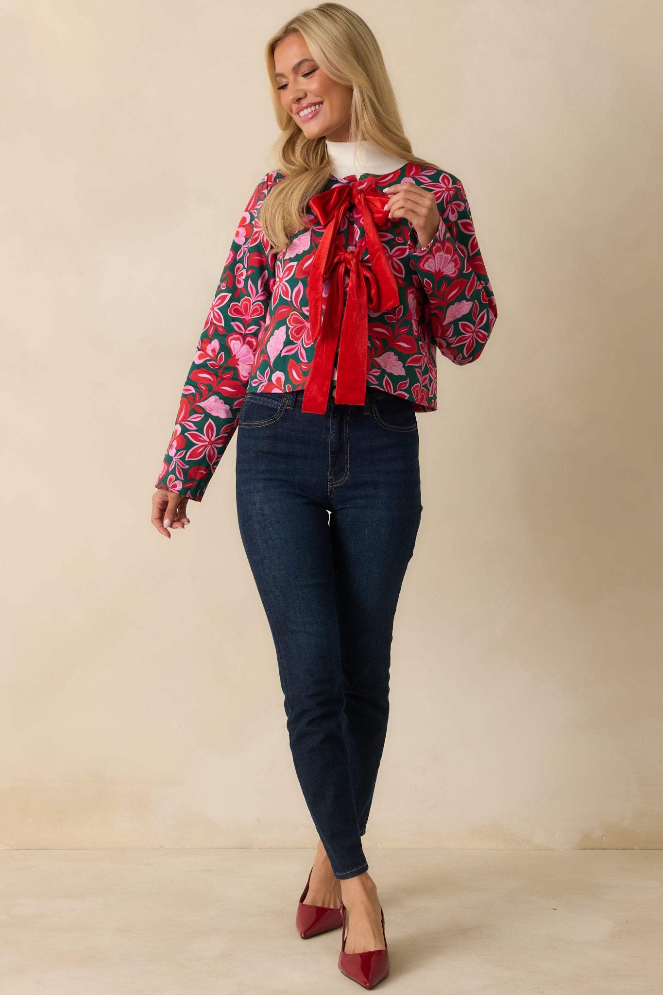The jacket shows its green and pink printed woven fabric with a boxy, cropped silhouette and long sleeves.