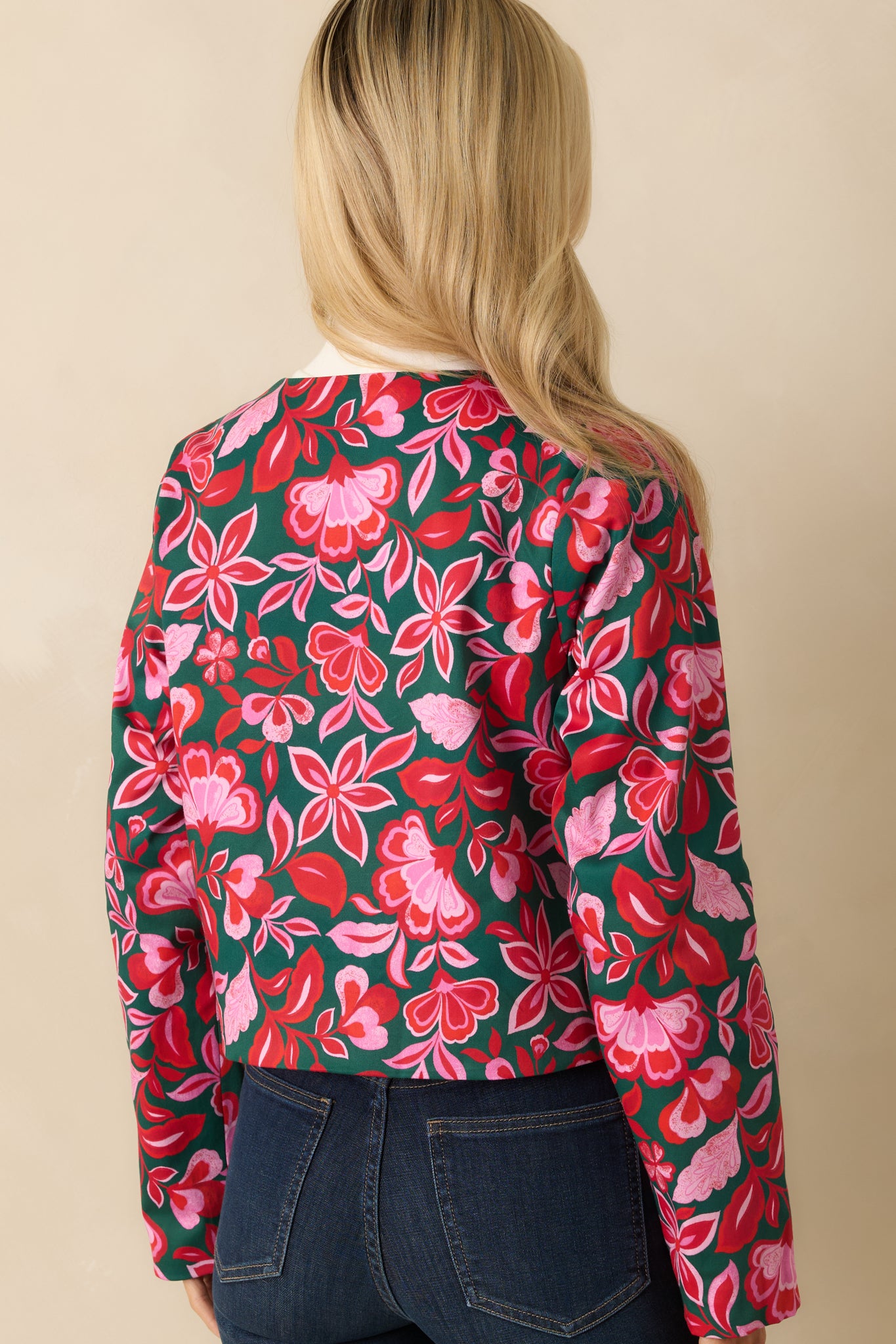 The back of the jacket shows the cropped boxy shape and continuous printed fabric with full lining.