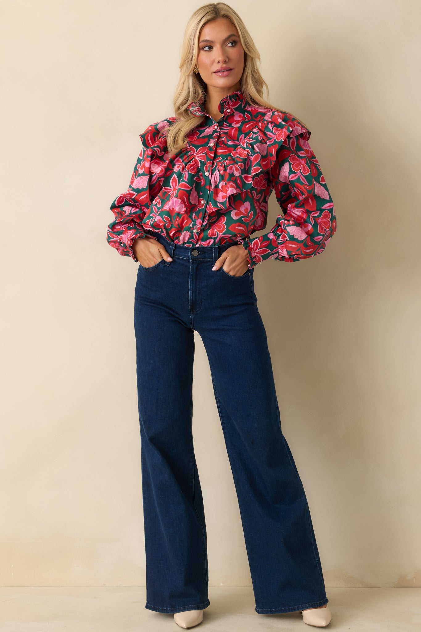 The top highlights its structured ruffles and polished cotton texture across the body and sleeves.