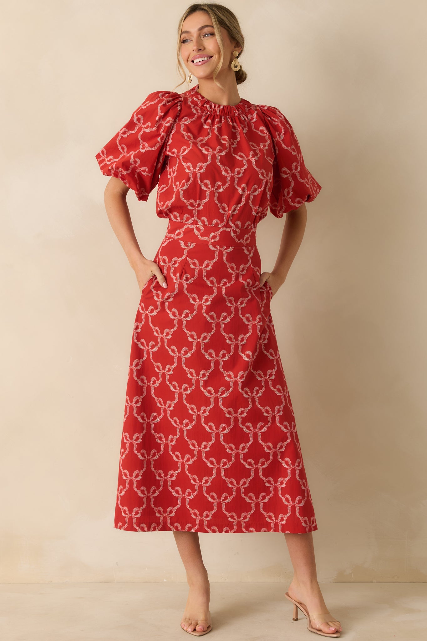 The bow-printed design stands out across the airy shape and neatly gathered neckline of the top.