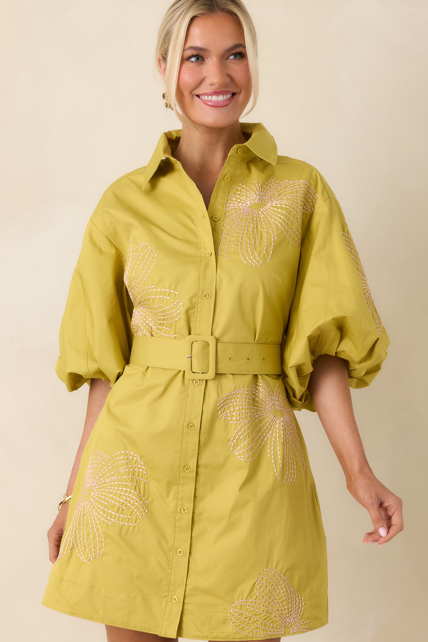 Close view of pink contrast embroidery on breathable cotton with subtle textured finish.