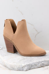 Close up view of these booties that feature a pointed toe, a stacked heel, and a slit on the ankle.