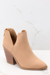 Outer-side view of these booties that feature a pointed toe, a stacked heel, and a slit on the ankle.