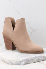 Close up view of these booties that feature a pointed toe, a stacked heel, and a slit on the ankle. 