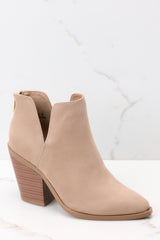 Outer-side view of these booties that feature a pointed toe, a stacked heel, and a slit on the ankle.