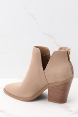 Inner-side view of these booties that feature a pointed toe, a stacked heel, and a slit on the ankle.