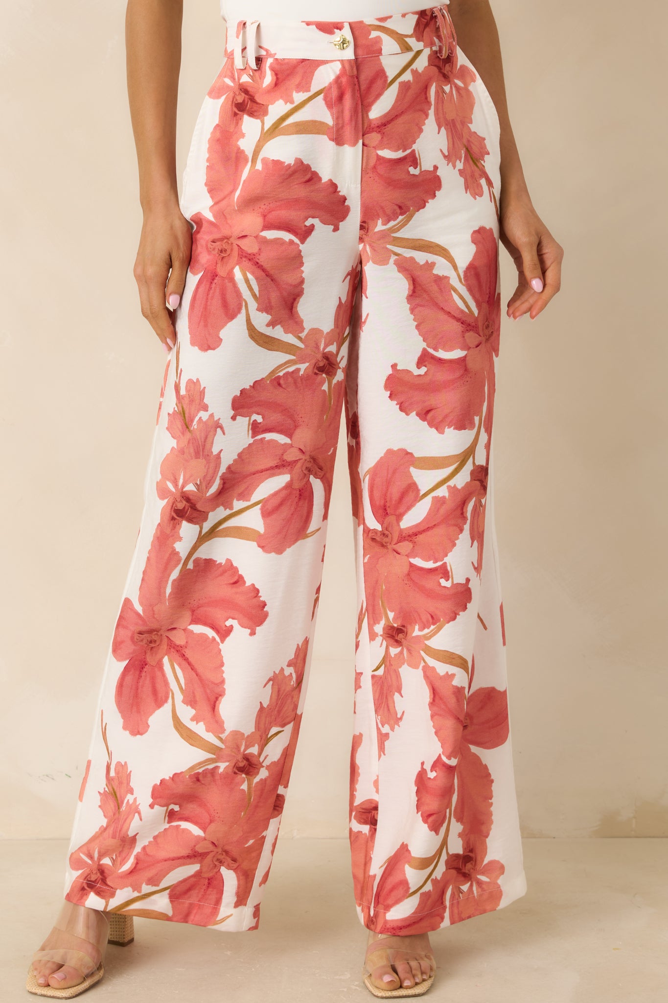 Cropped view of peach hibiscus pants highlighting the wide leg shape and lightweight drape.