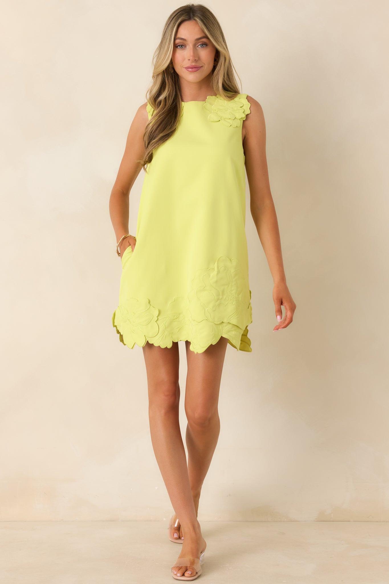 Relaxed chartreuse mini dress with textured floral appliqué and easy shift silhouette.