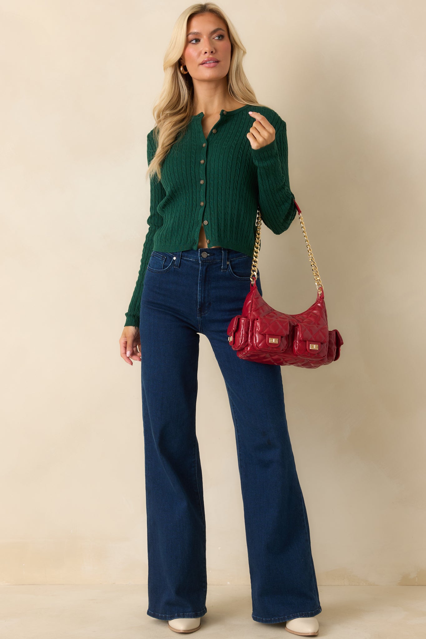 Hunter green cardigan showcasing a lightweight cable knit texture with a classic button front