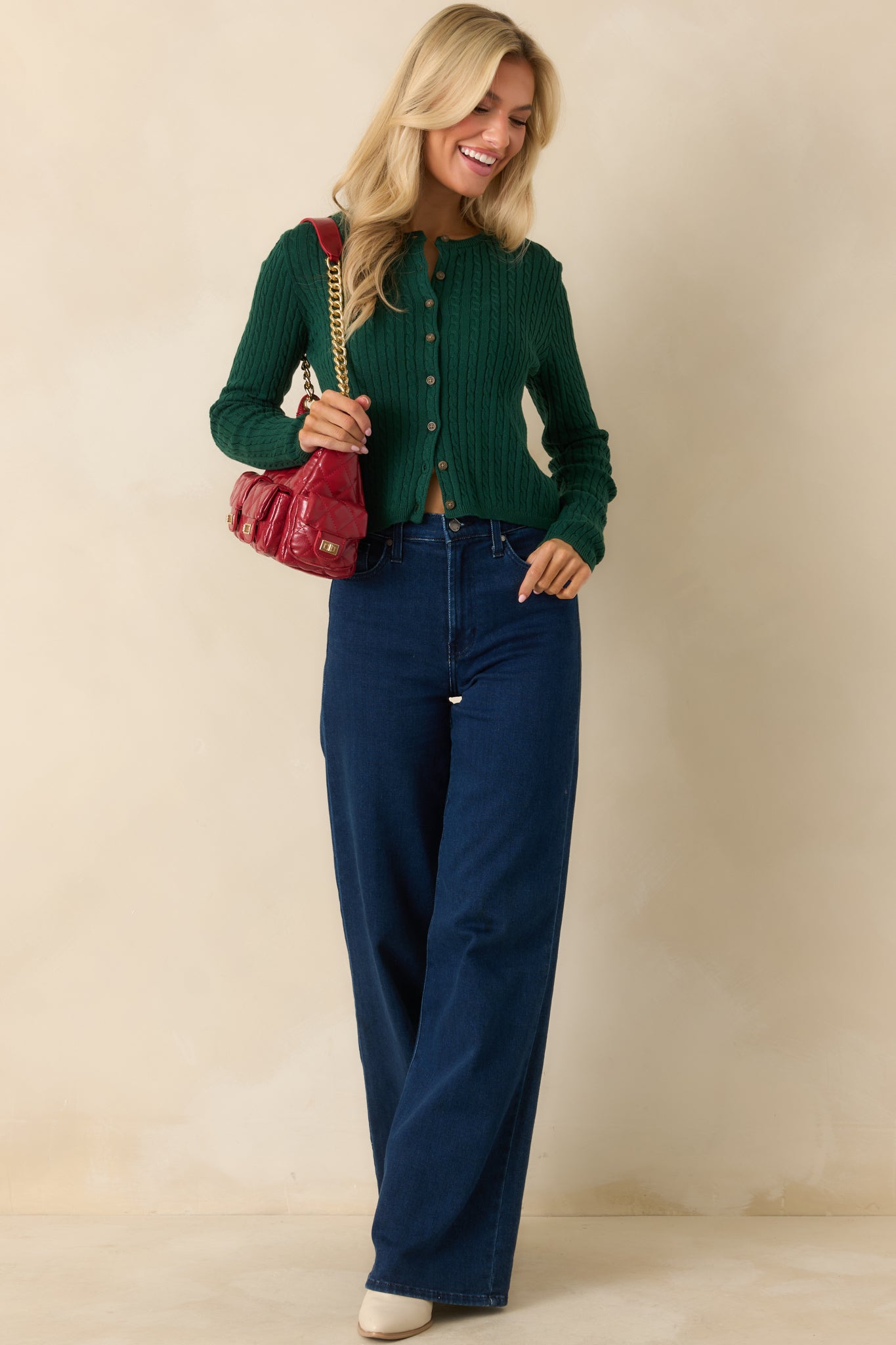 Hunter green cardigan featuring long sleeves and a refined, everyday knit design