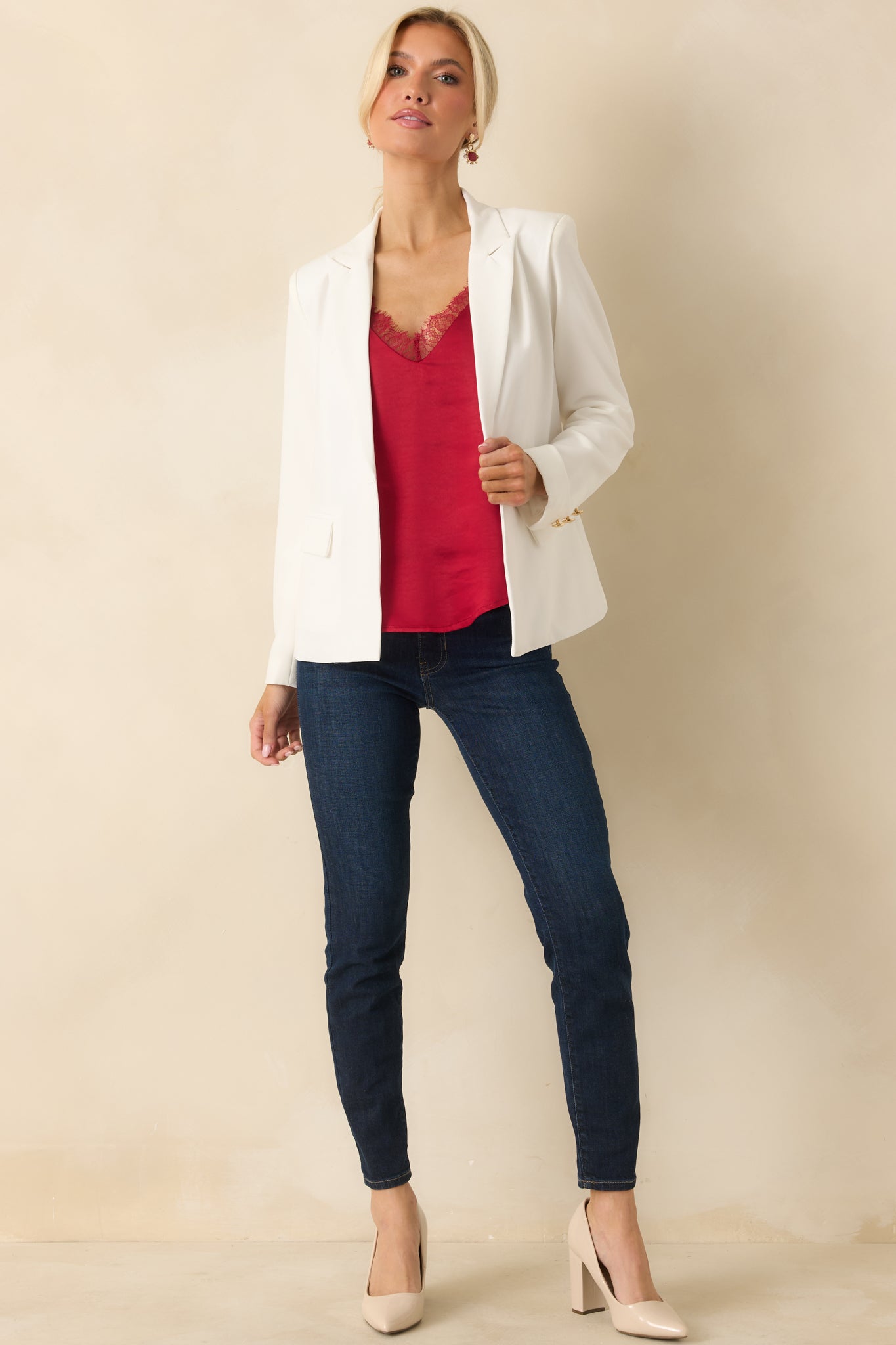 Full-length front view highlighting blazer’s gold buttons and tailored design.