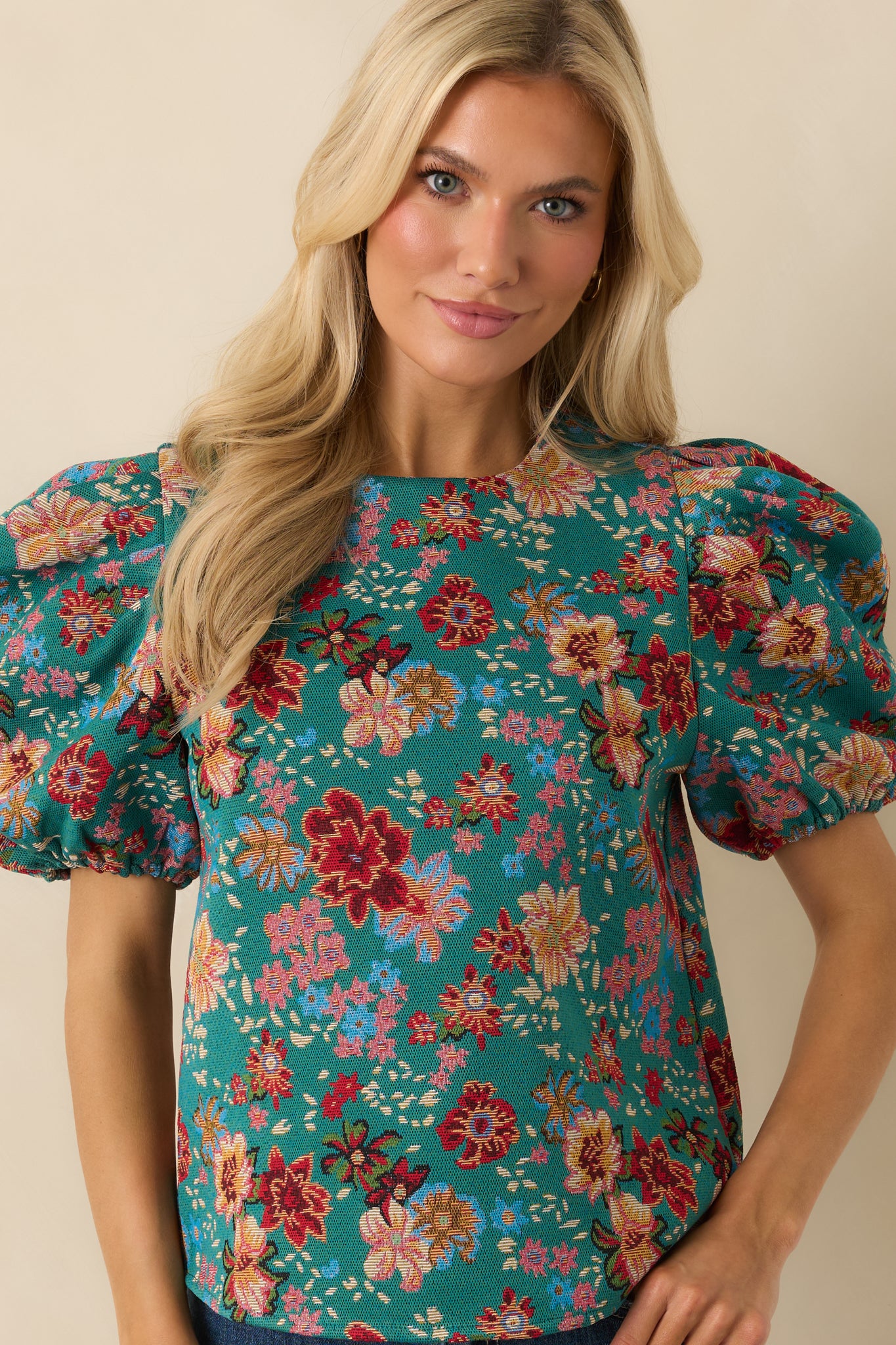 Lightweight teal-green top with short puff sleeves and subtle tailoring through the bodice for shape.