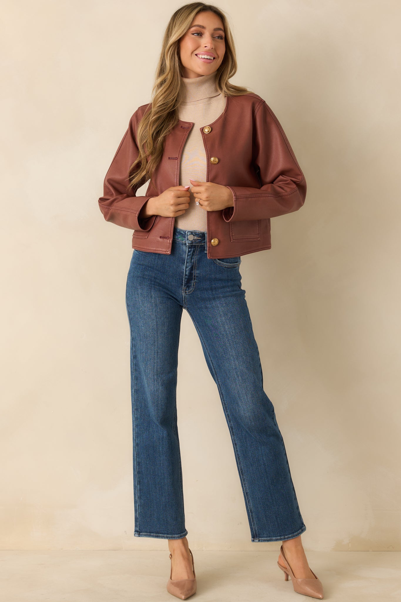 Mauve faux leather jacket showing structured seaming and sleek silhouette.