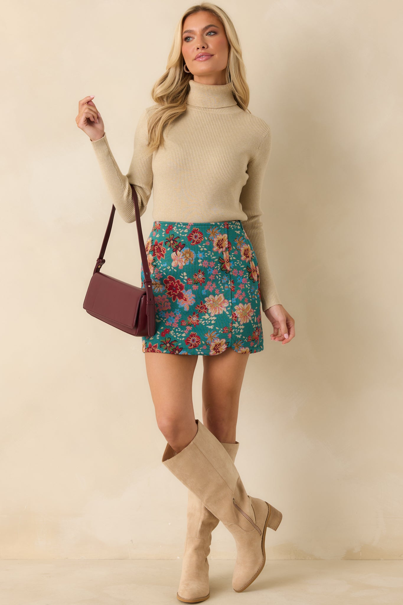 Teal-green mini skirt featuring a straight silhouette, allover multicolor floral print, and smooth waistband.