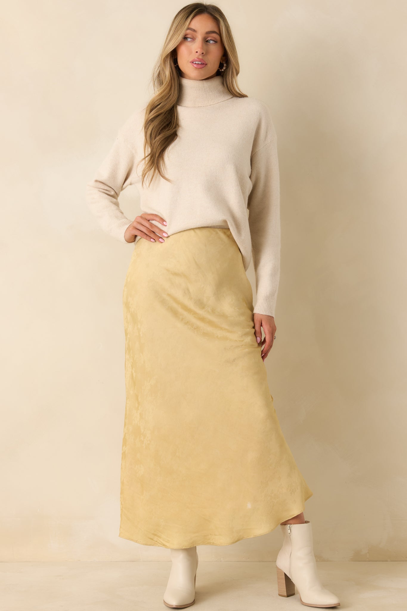 The bias-cut maxi skirt displays its full length with subtle shimmer and structured drape