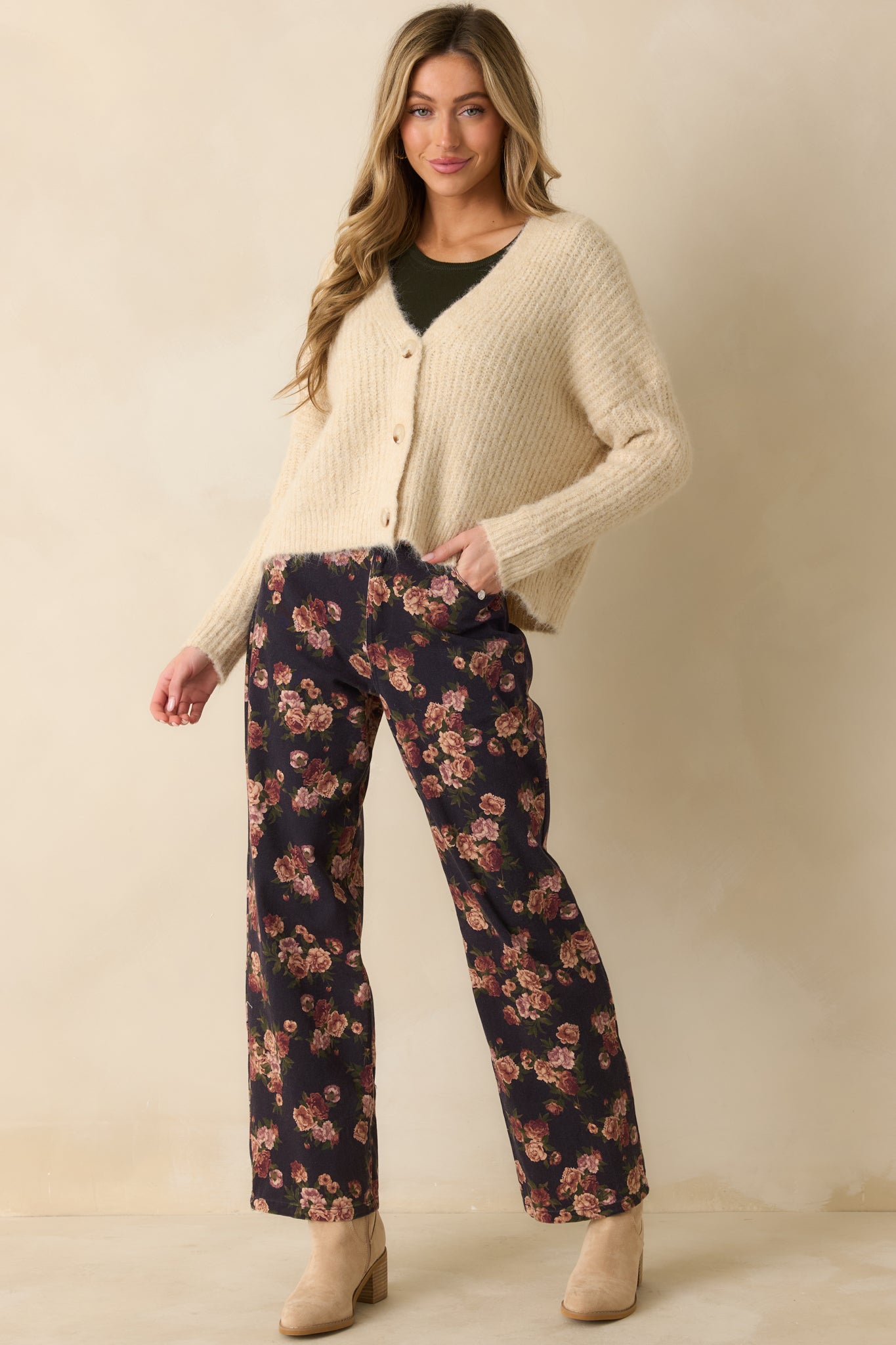 Long-sleeve ivory cardigan showing the functional button closure and soft ribbed texture for a casual, cozy look.