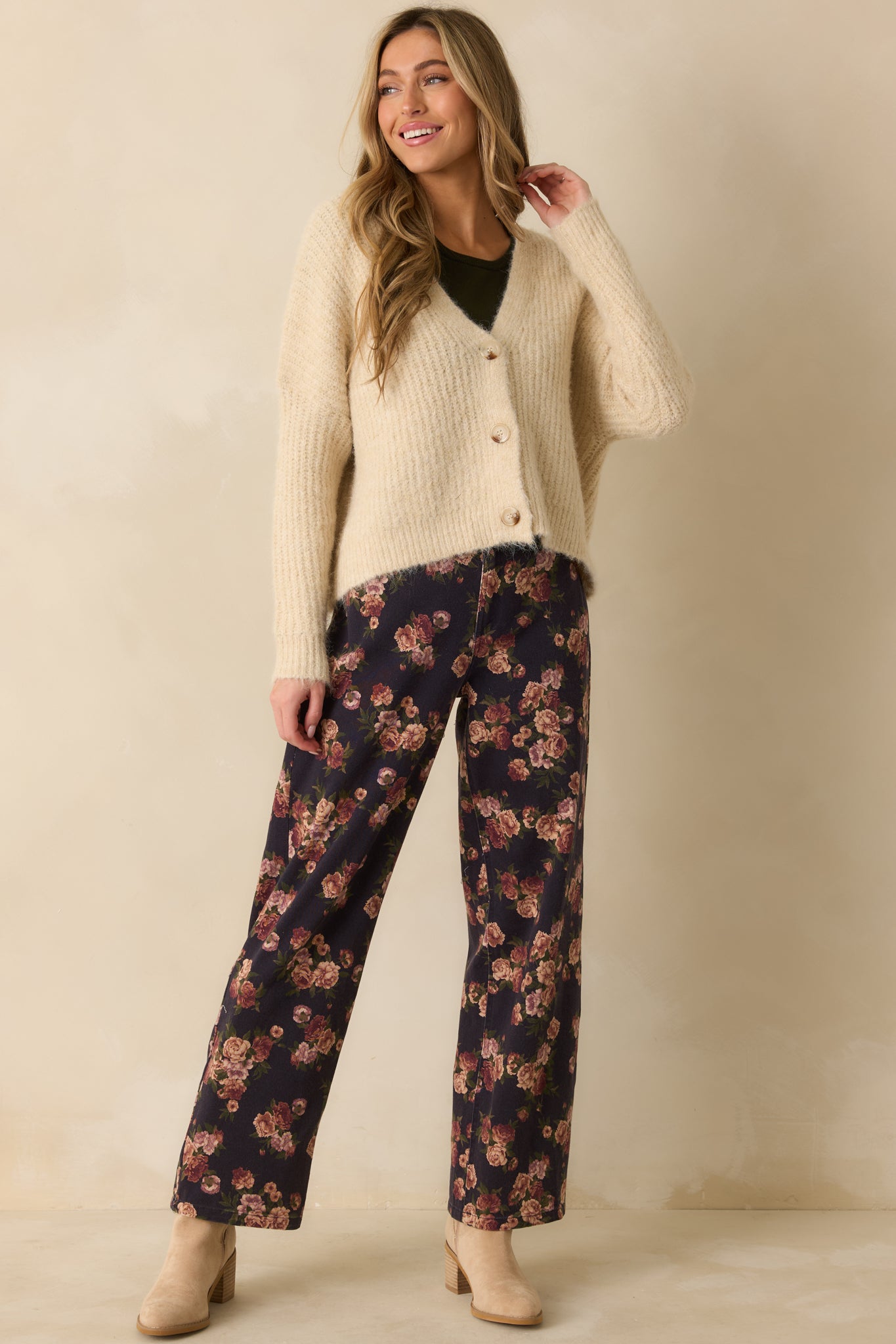 Relaxed-fit ivory knit cardigan with a classic v-neck and subtle texture emphasizing the tortoise shell buttons.