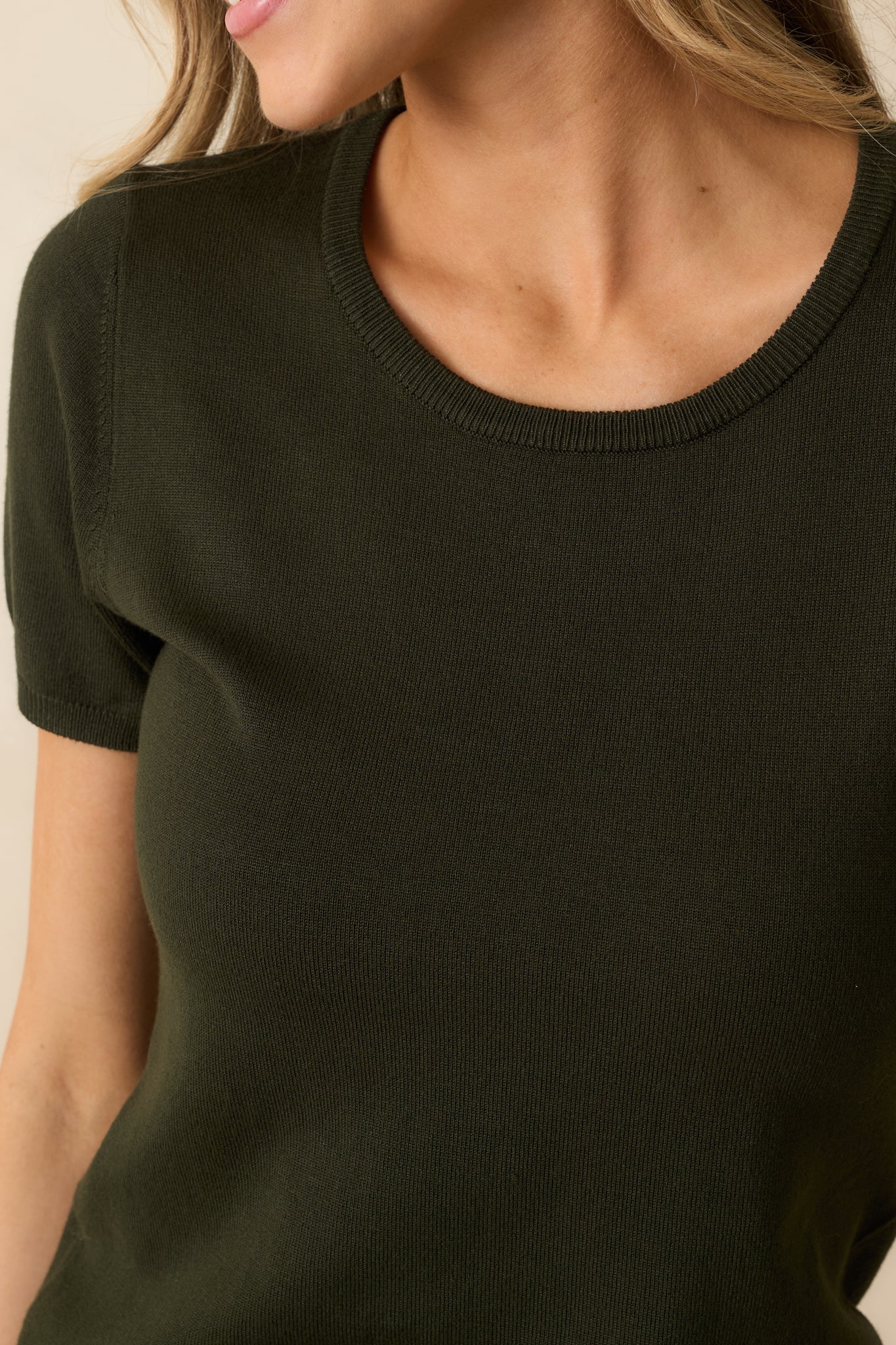 Detailed shot of the sweater’s fabric showing the ribbed stitching and cozy, fine-knit texture.