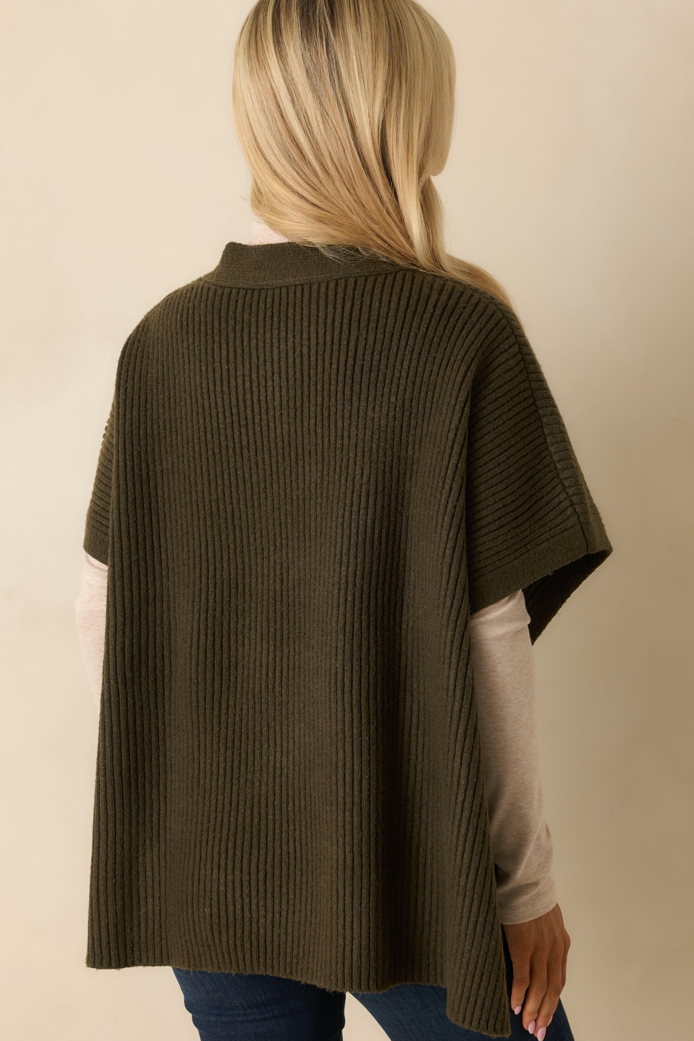 Rear view of olive green cardigan showing relaxed fit, short sleeves, and ribbed knit texture.