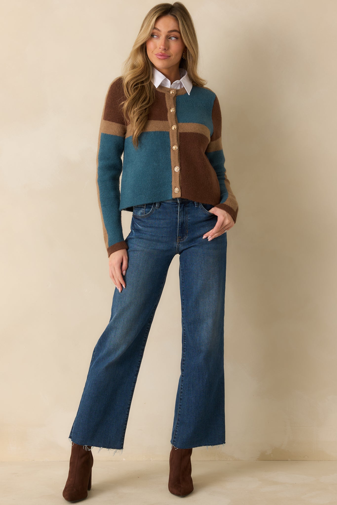 Brown, camel, and teal color block knit cardigan with a round neckline and long sleeves.